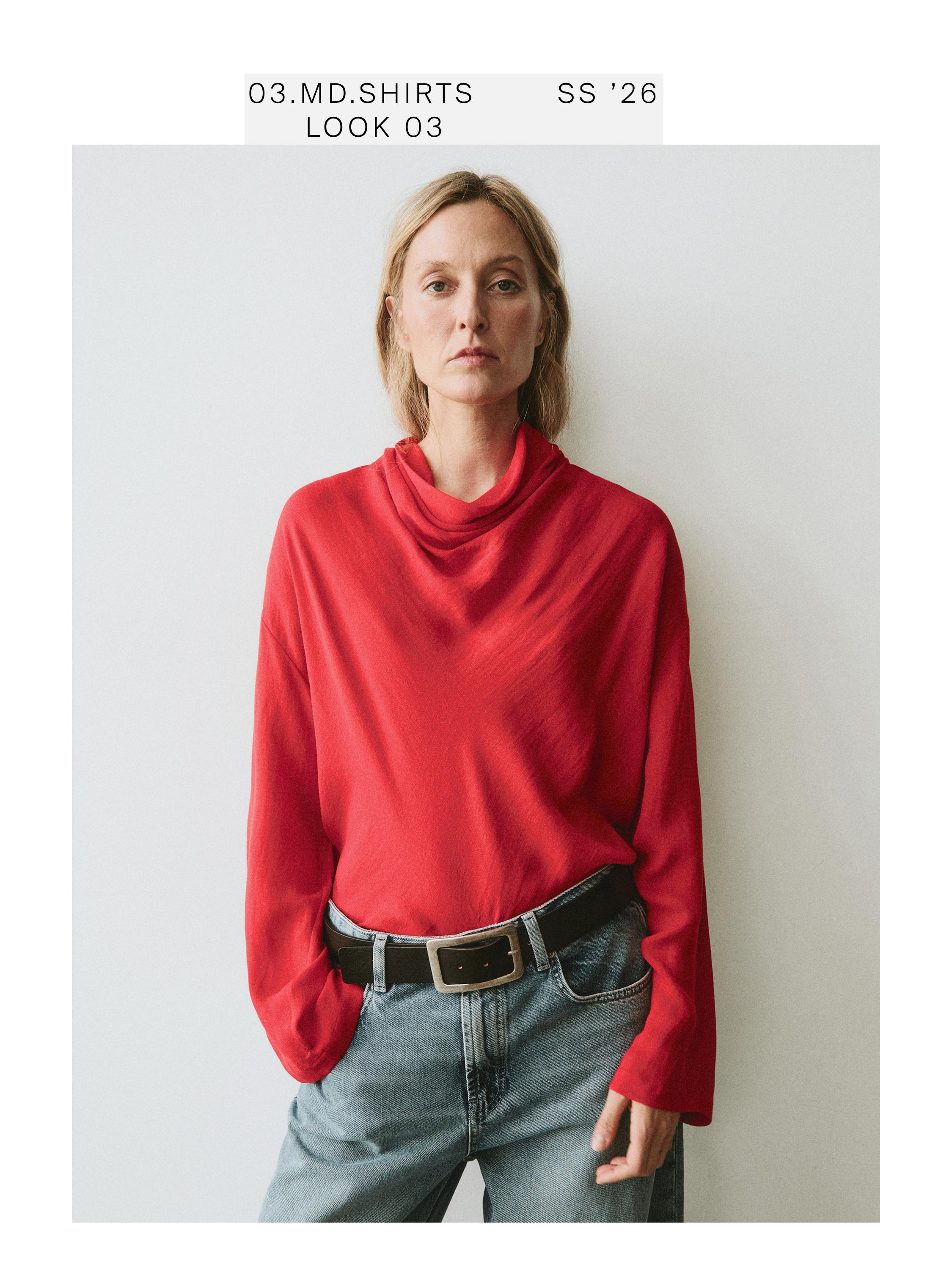 Coral draped-neck blouse and blue jeans set with a black belt. Visible text: "03.MD.SHIRTS SS '26 LOOK 03".