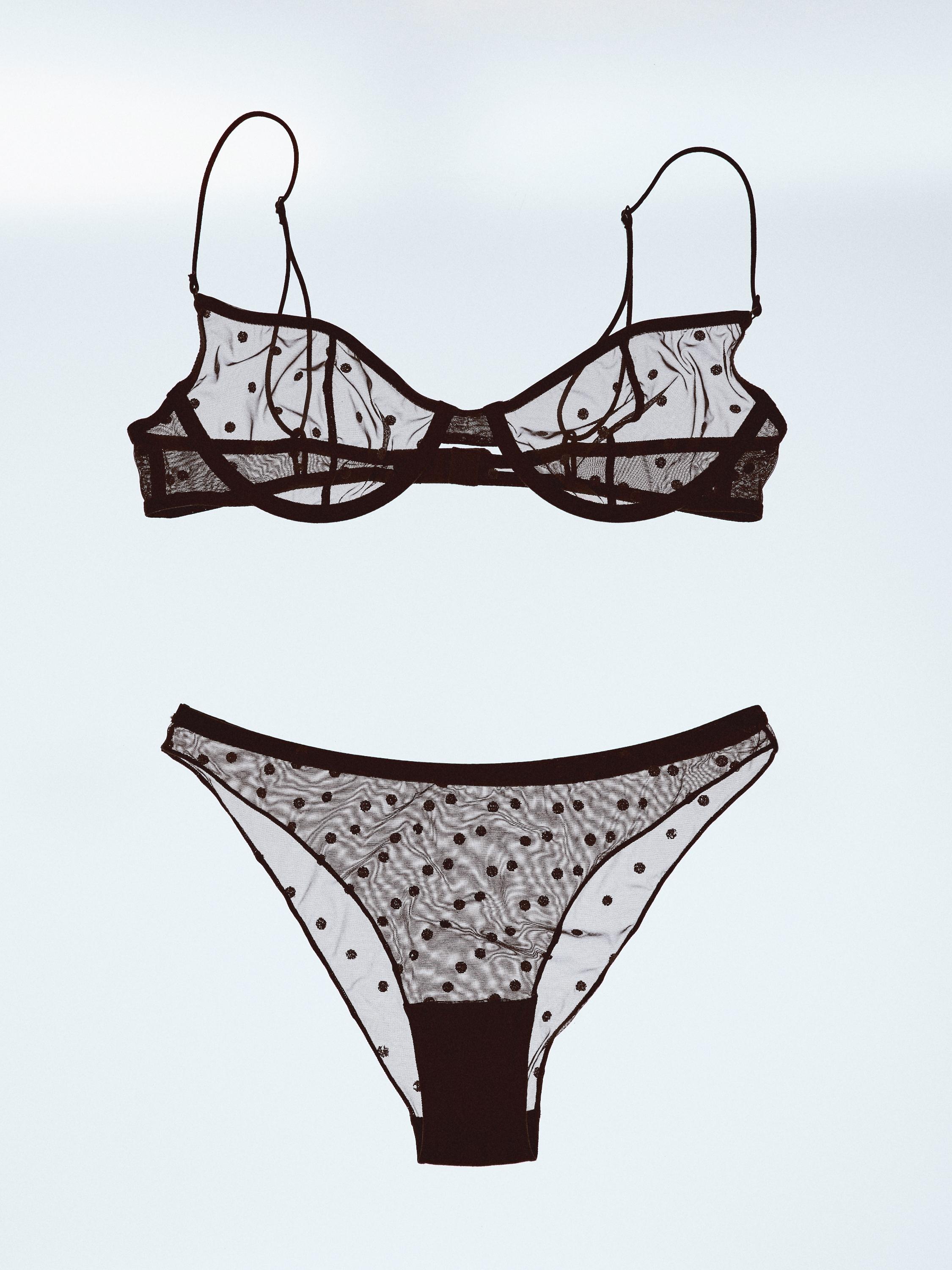 Conjunto de lencería negro transparente con estampado de lunares. Sujetador con tirantes finos y bragas a juego.