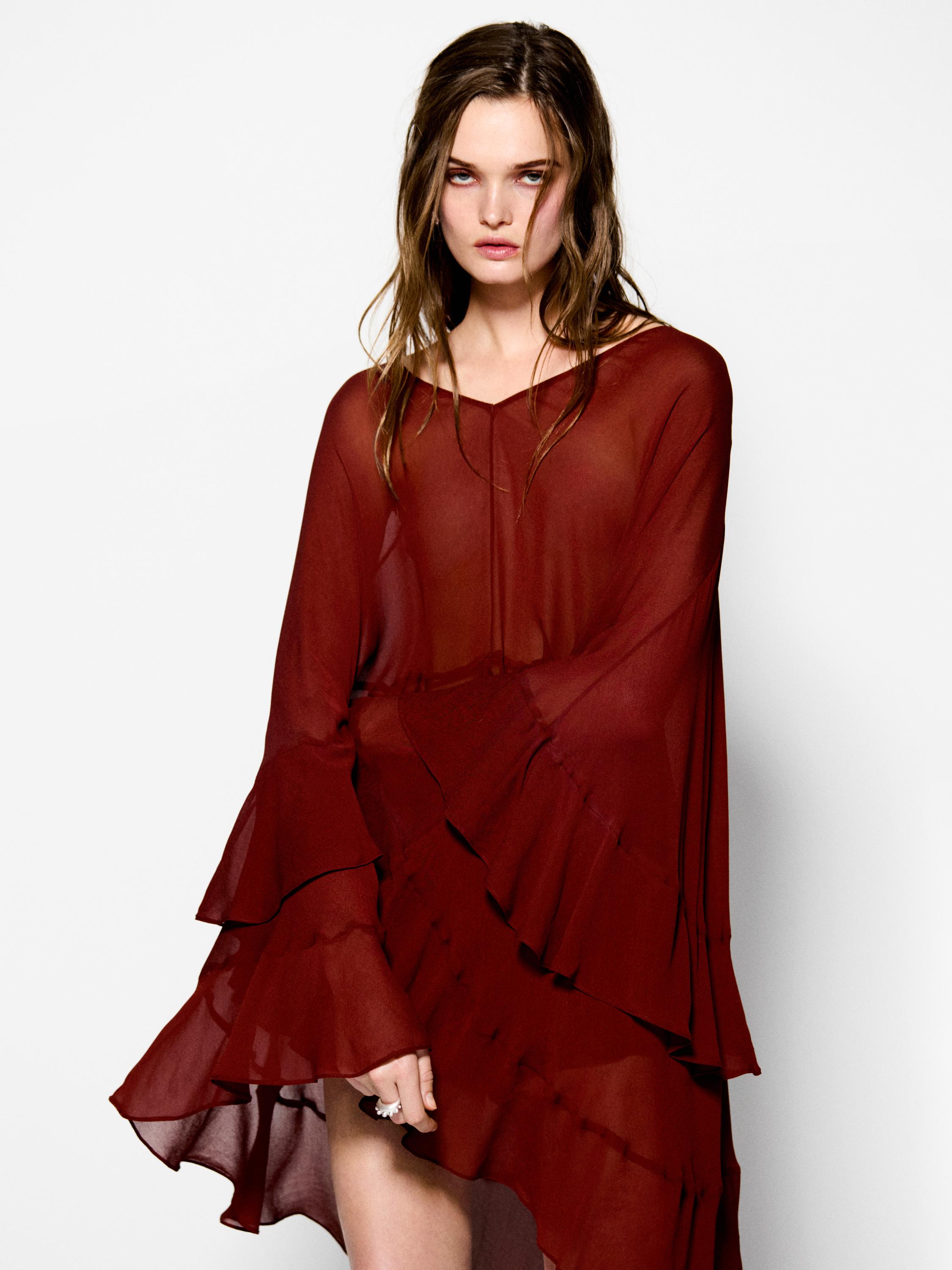 Cape-style blouse with ruffles