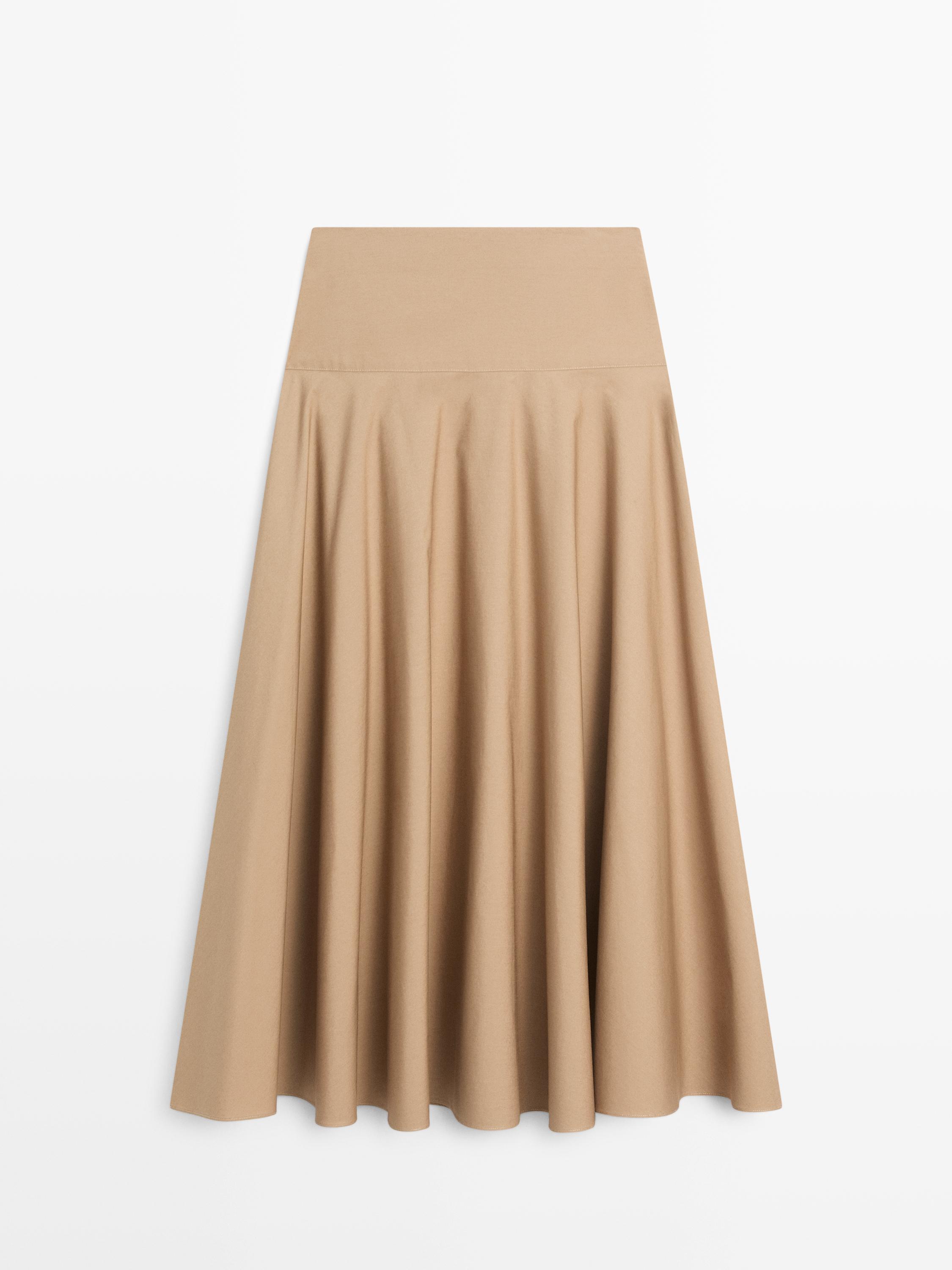 Front view of a camel midi skirt with a yoke and flare.