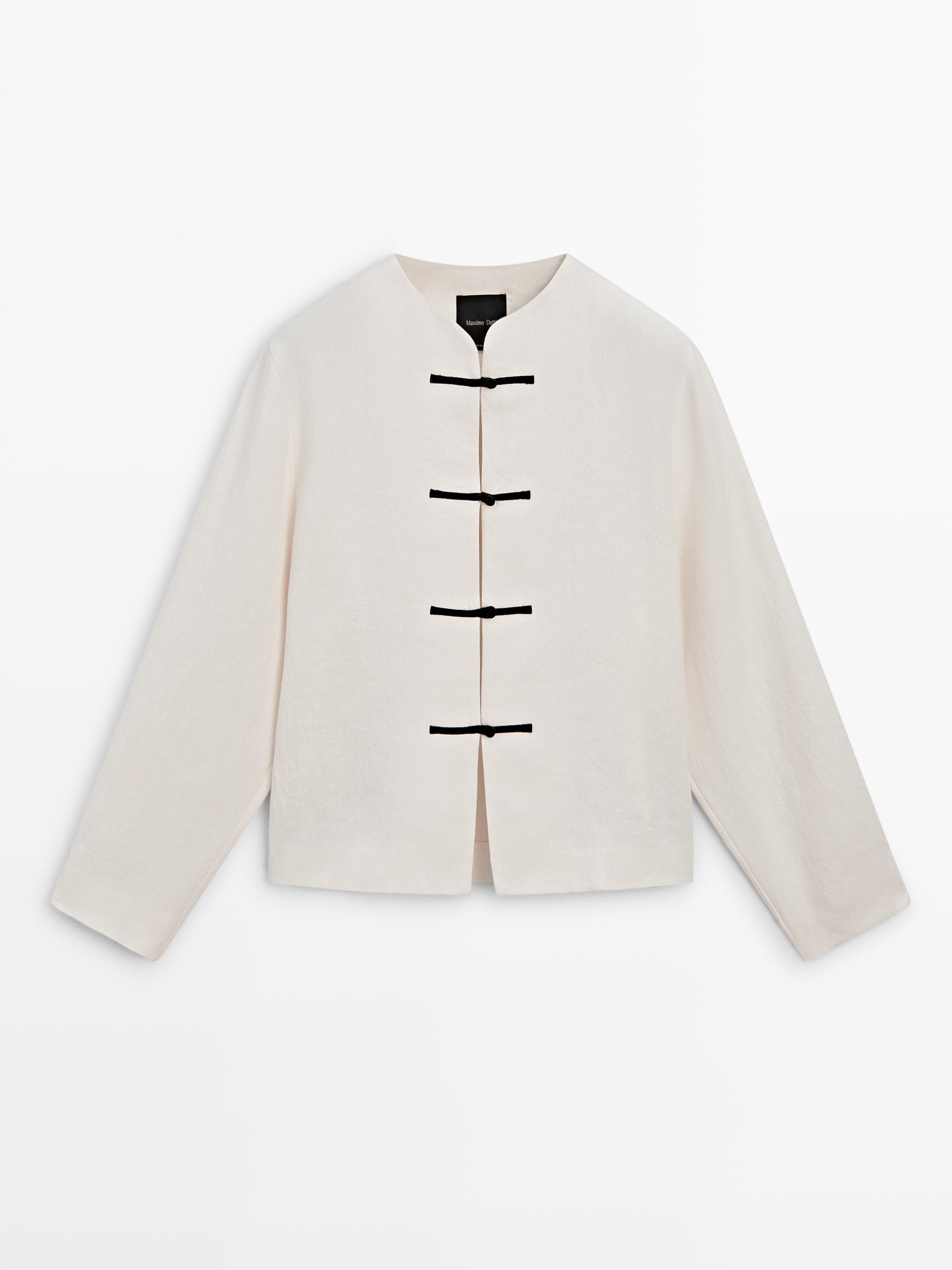 Front view of a raw blazer with black tie closure and round neck.