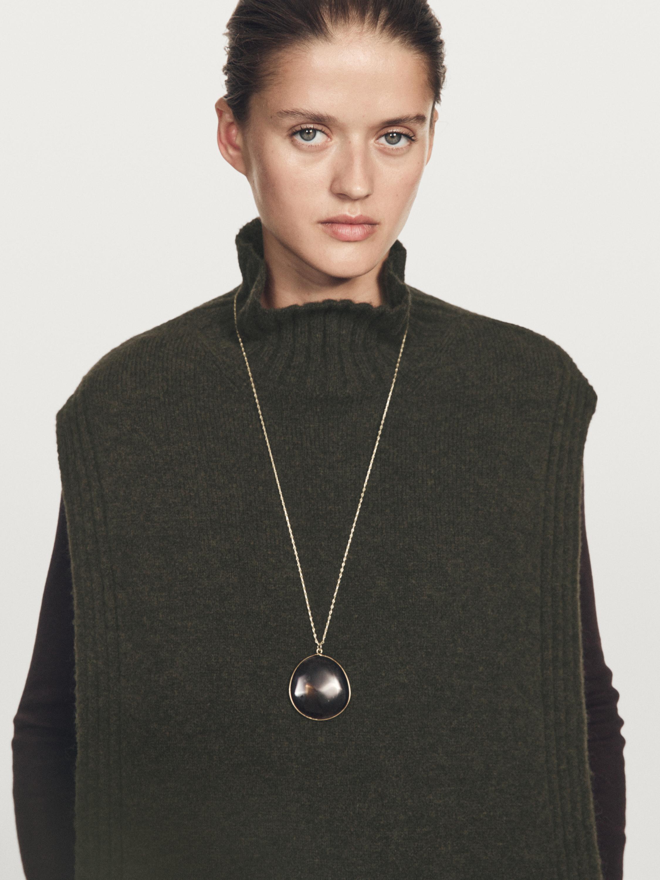 Sleeveless high neck sweater