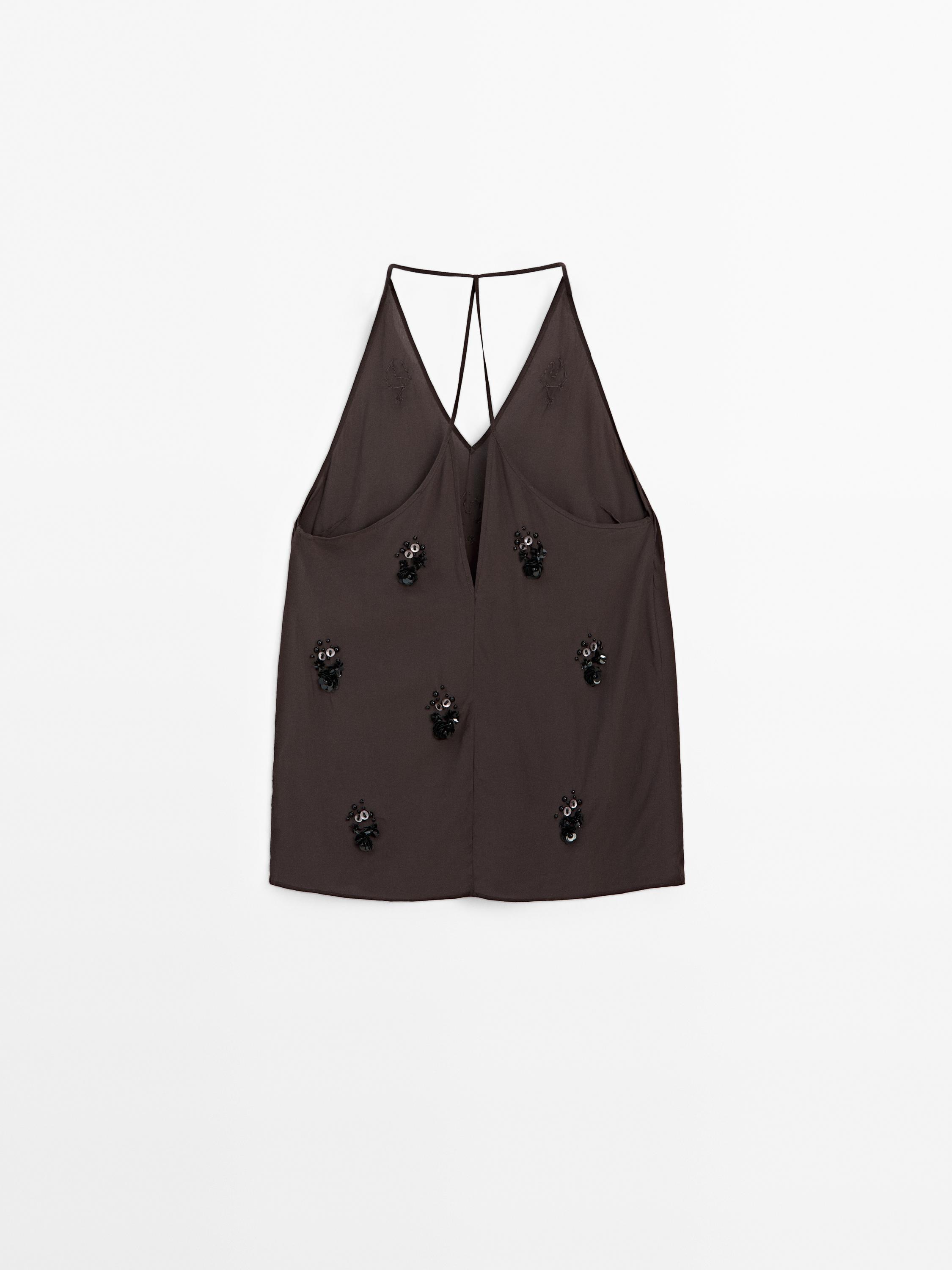 Flowing top with floral appliqués