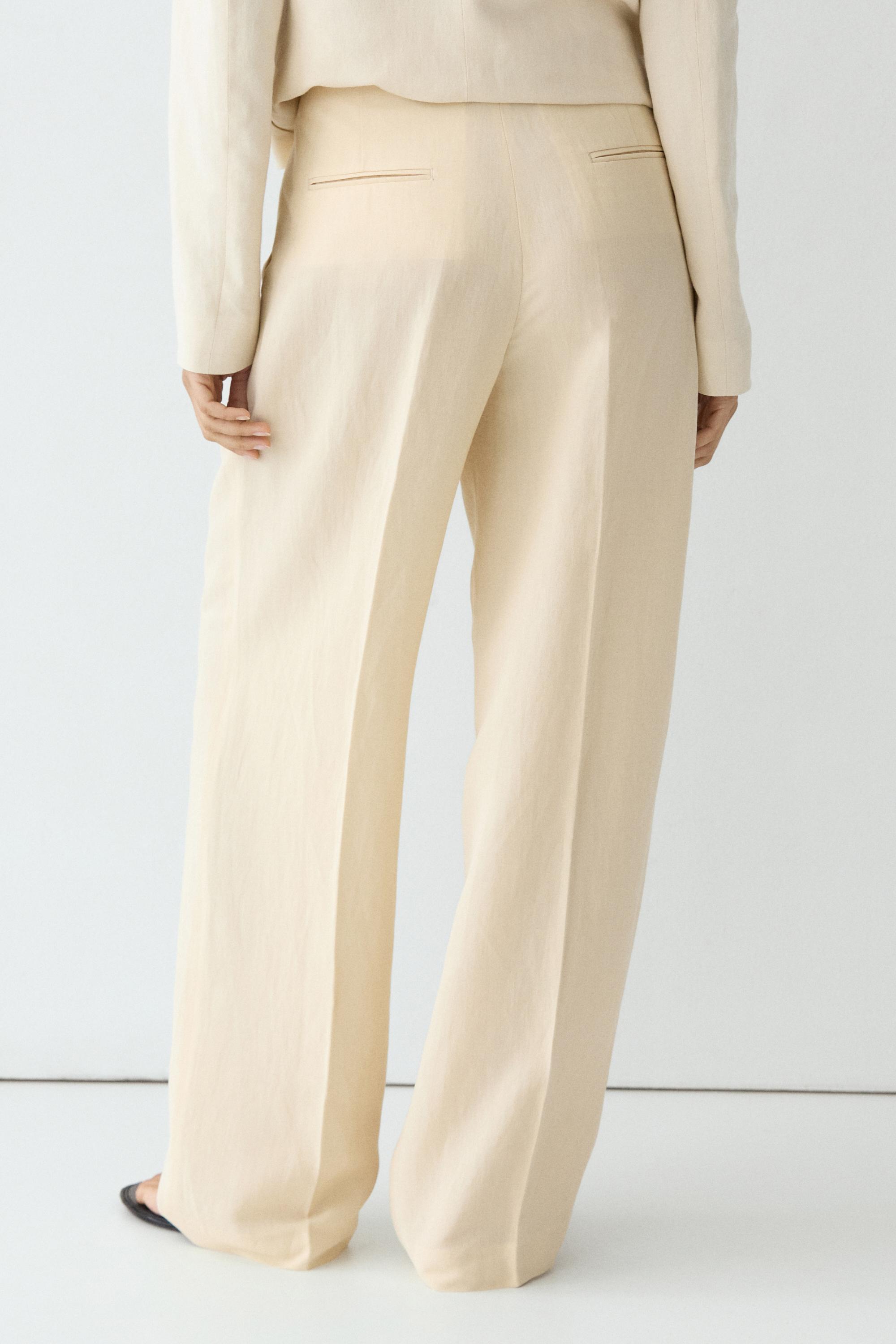 Flowing trousers with pleats — Beige