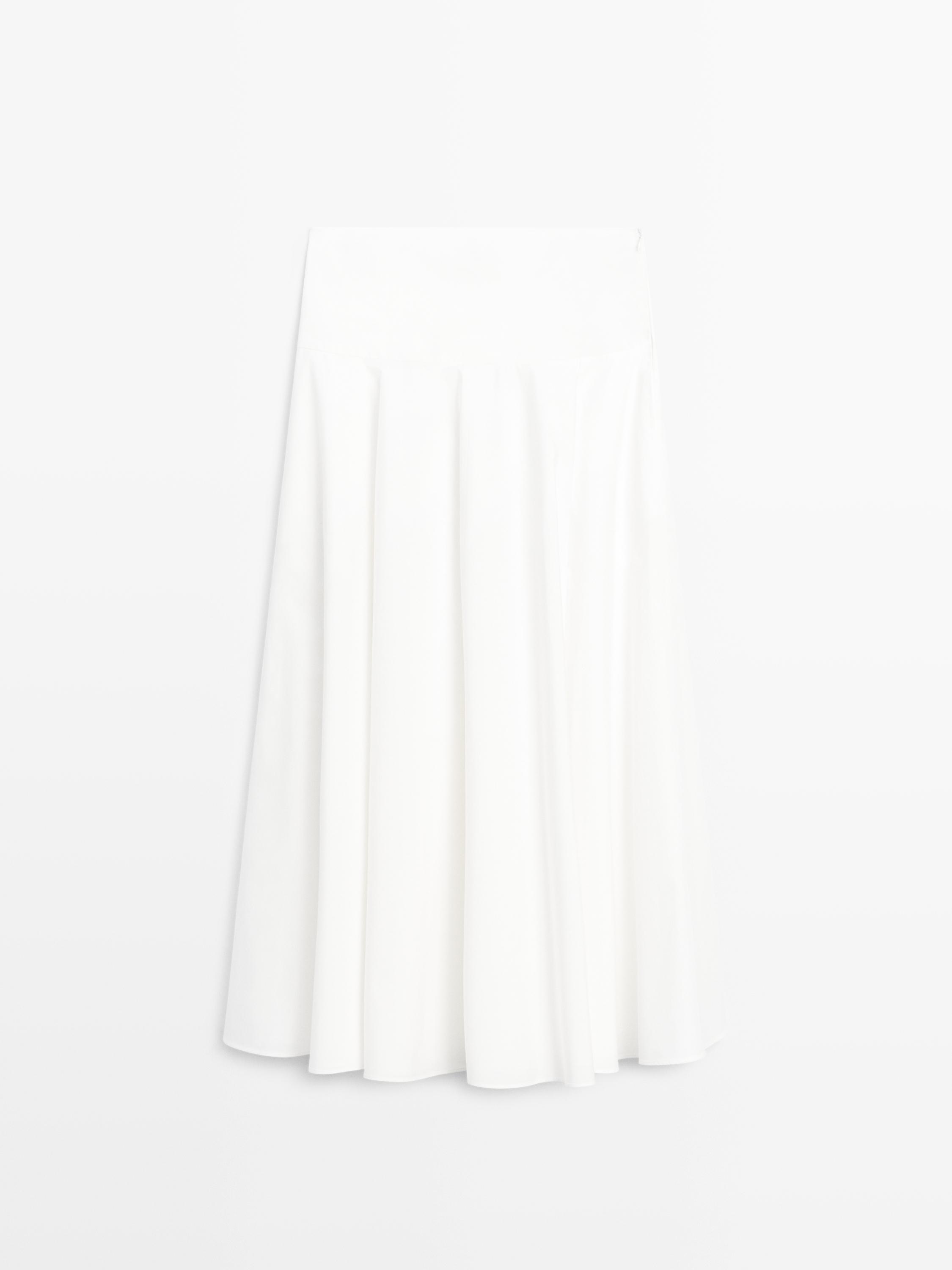 Front view of white midi skirt with yoke and pleats.