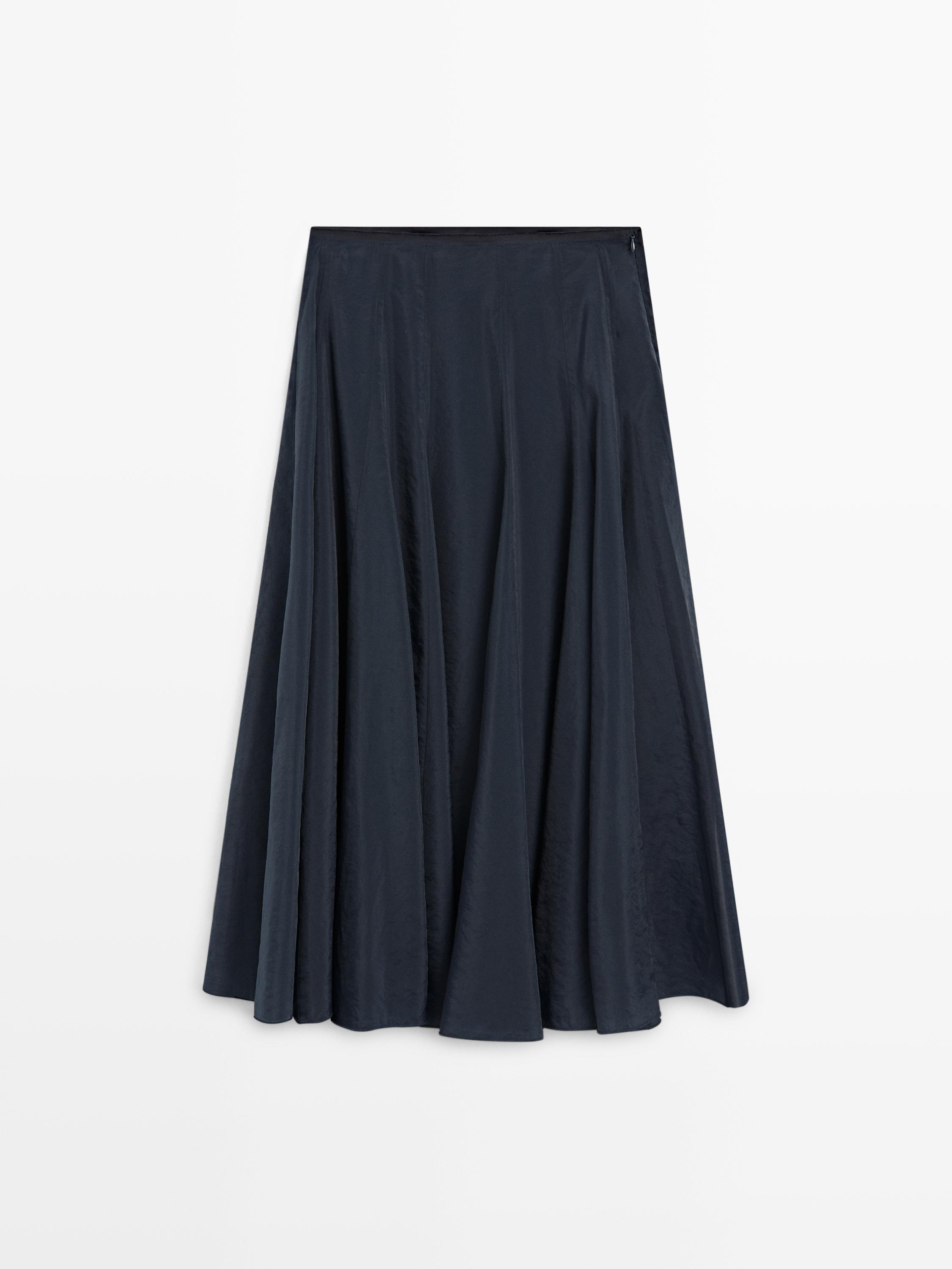 Front view of a dark blue midi skirt with pleats and a wide cut.