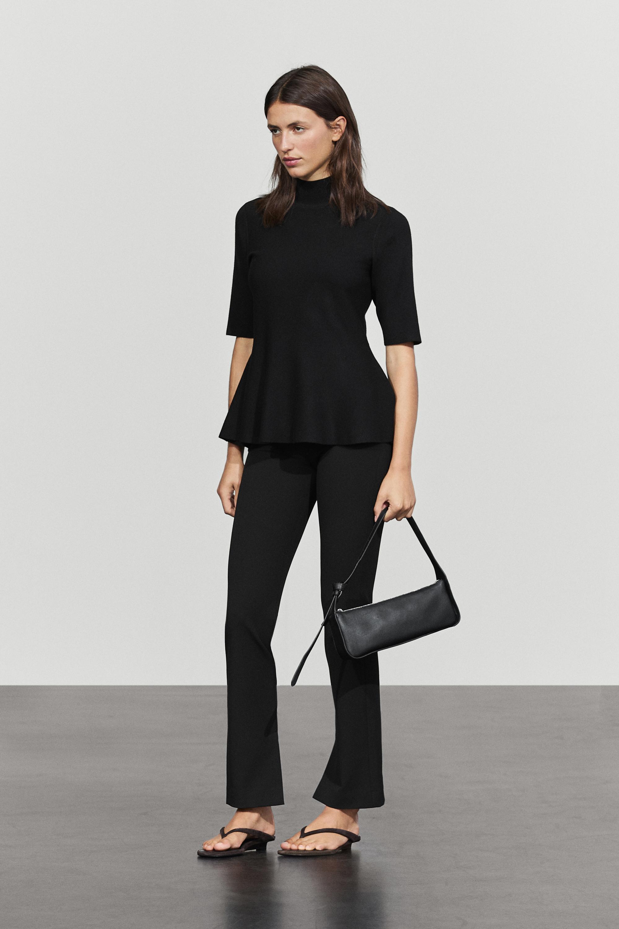 Peplum detail knit top — BLACK