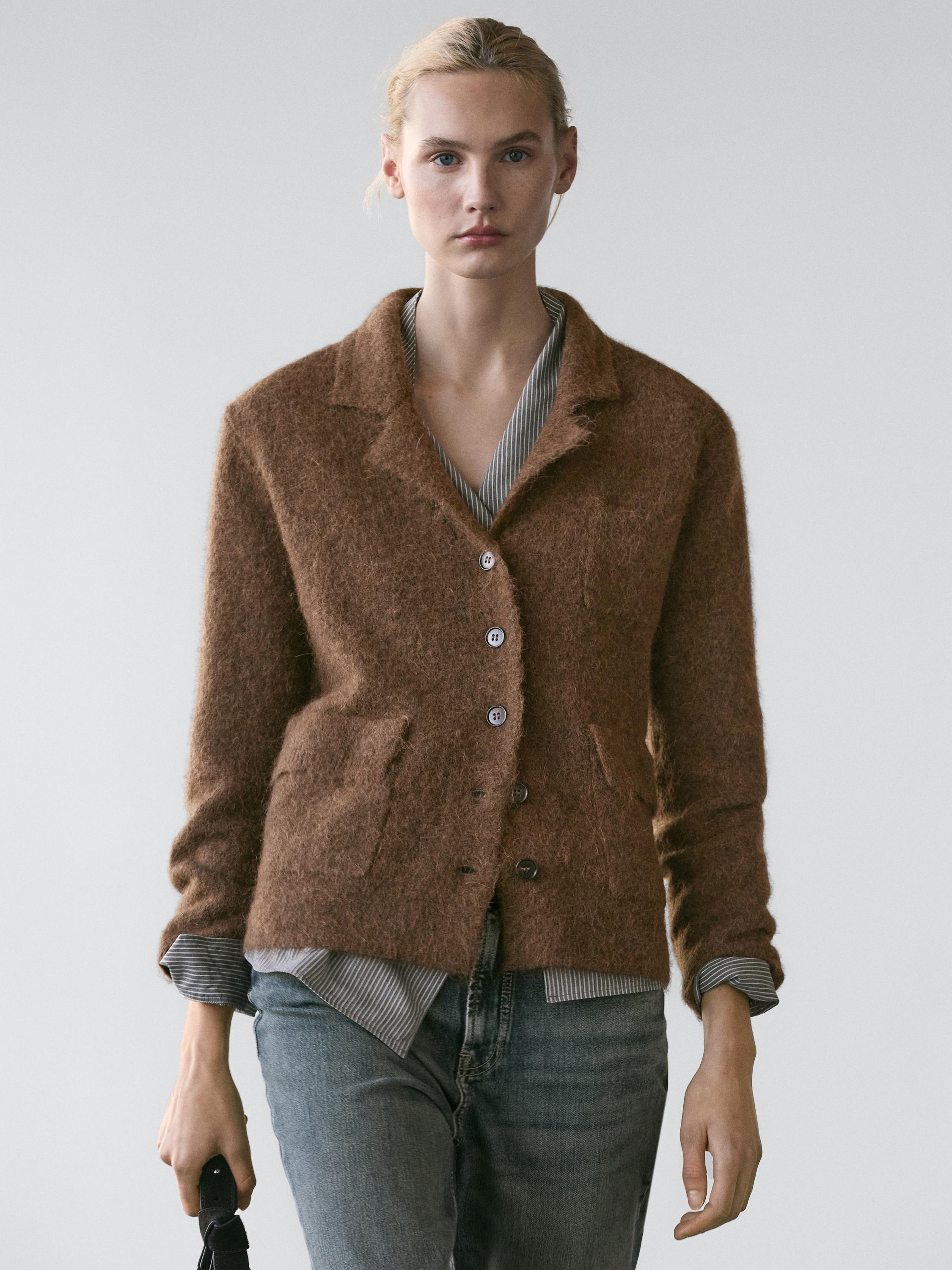 Toasted cardigan set with buttons and front pockets, striped shirt, and gray jeans.