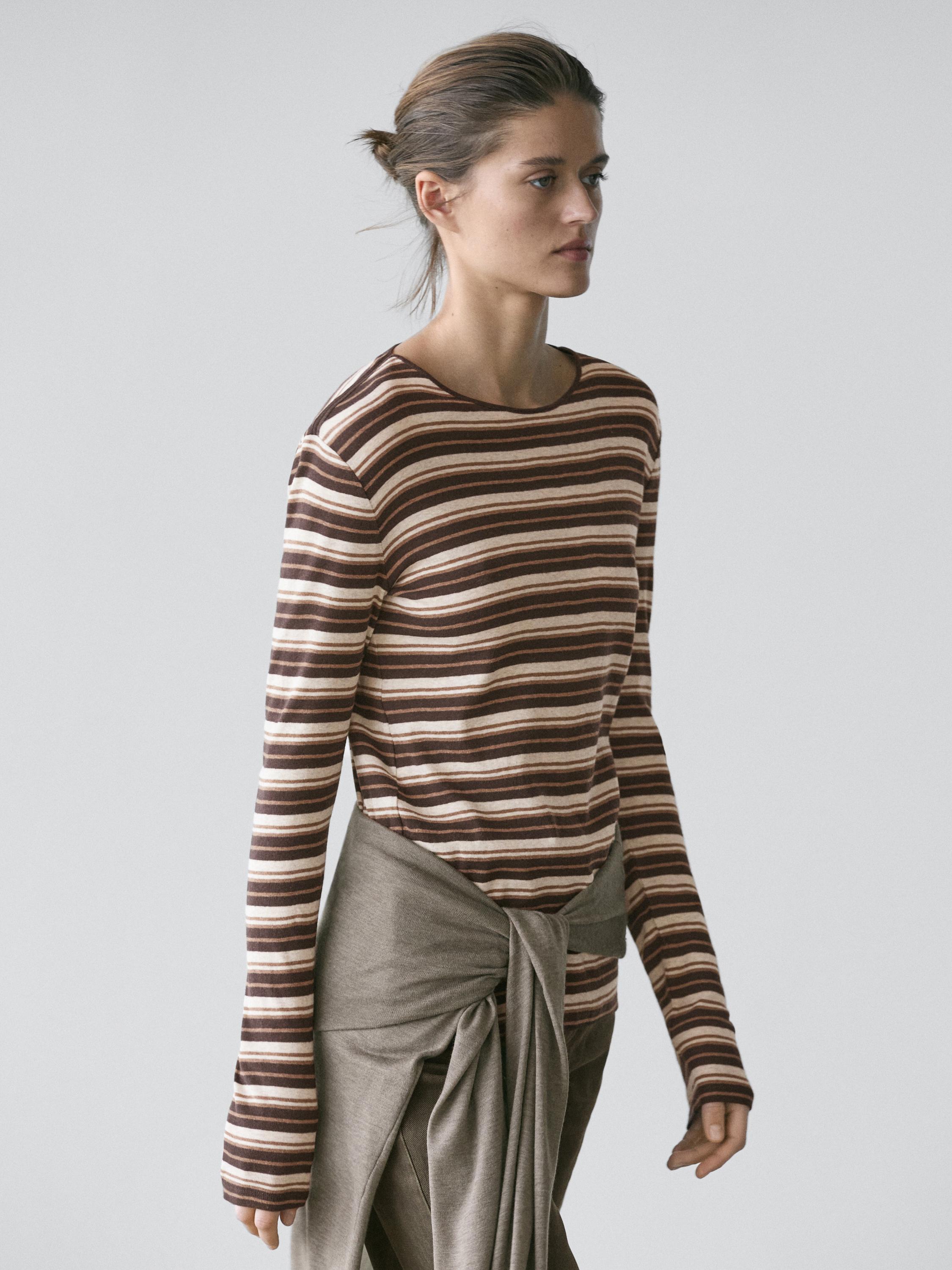 Medium shot of a brown long-sleeved T-shirt with horizontal stripes.