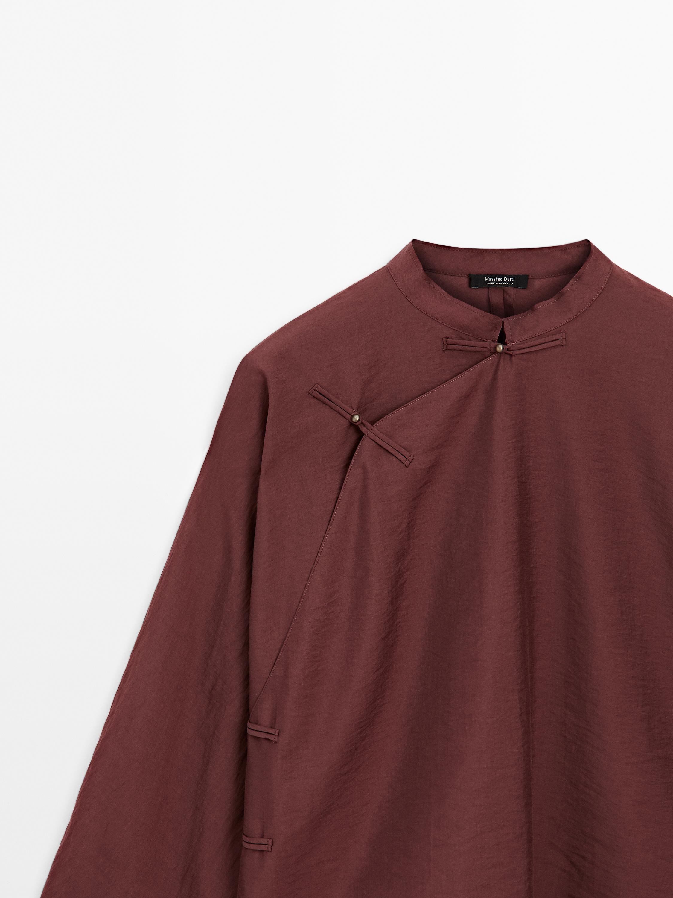 Flowing blouse with fastening detail