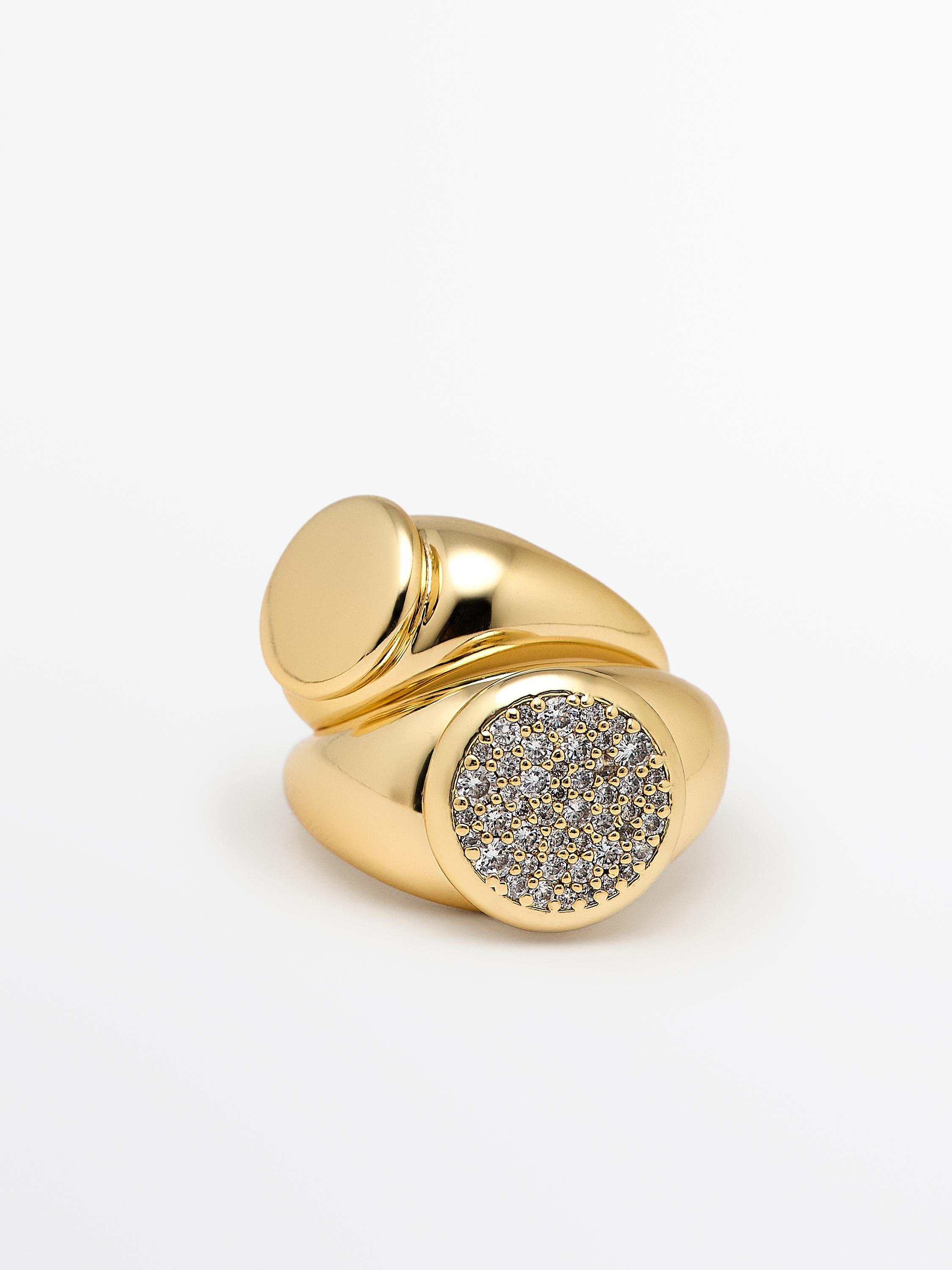 Set de bagues dorées, l'une avec une surface lisse et l'autre avec des incrustations brillantes sur le dessus.