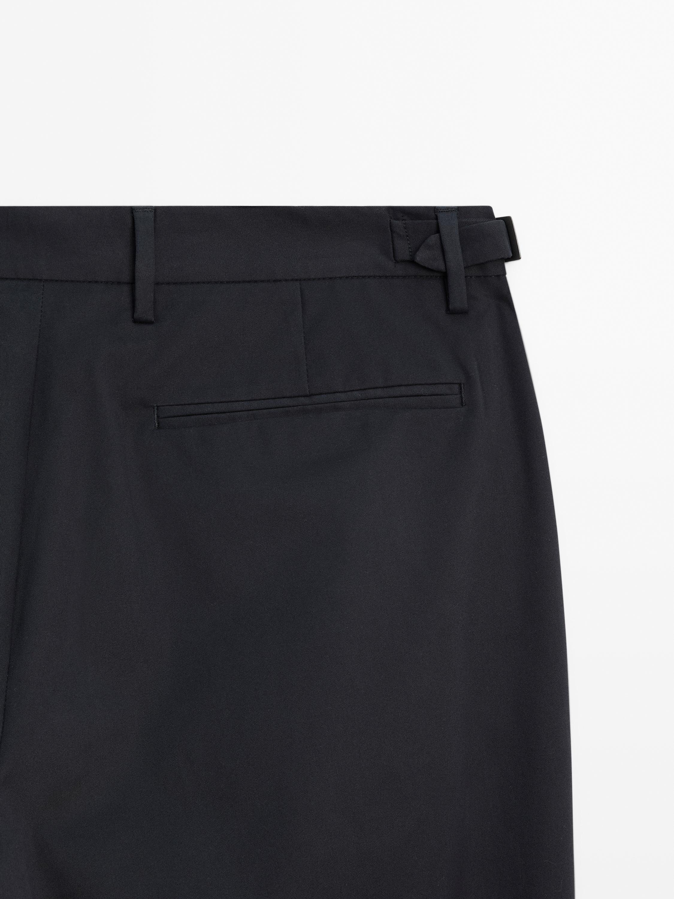 Tapered fit trousers with buckle detail