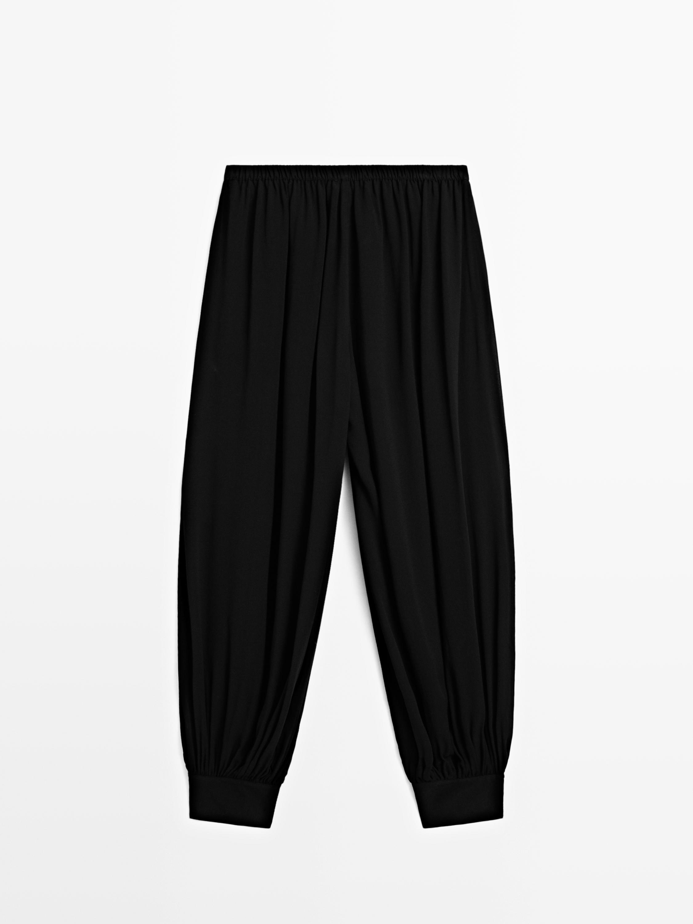 Semi-sheer sarouel trousers with button details — BLACK