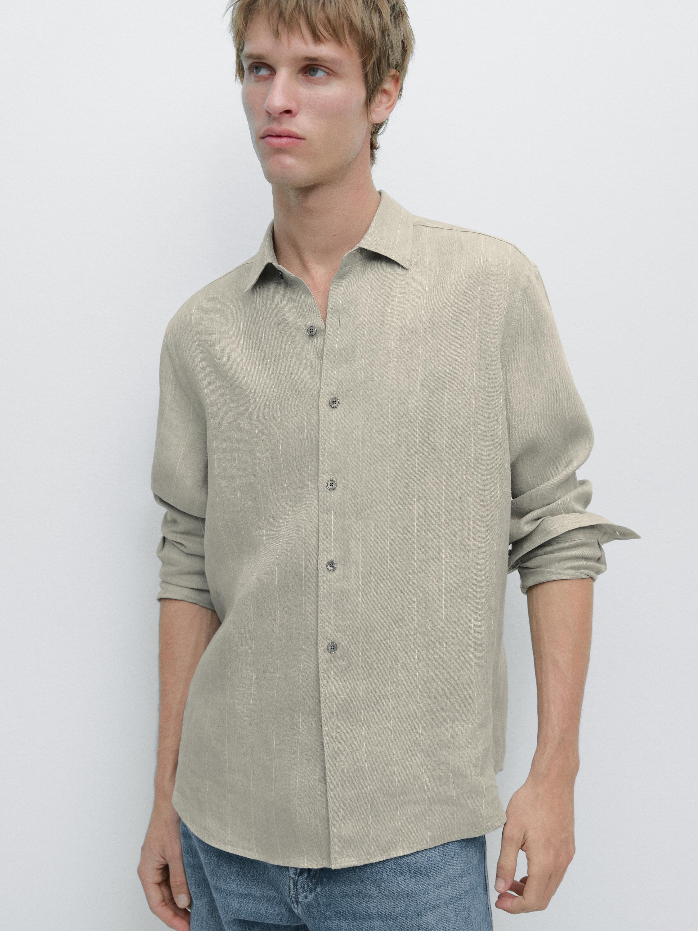 Light green striped long-sleeve shirt with front buttons, paired with blue jeans.