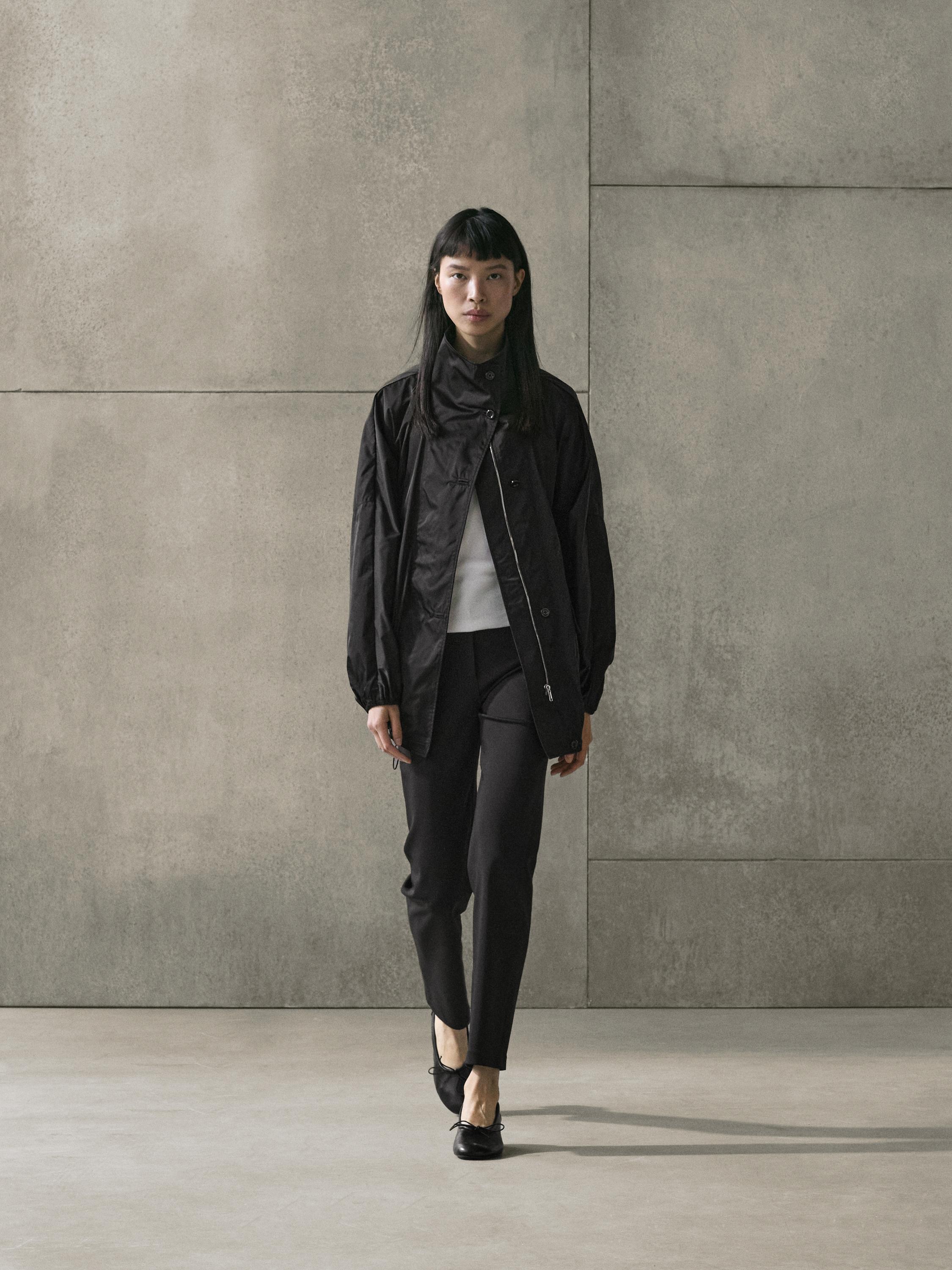 Blue coat set with buttons, black skinny pants, and black flat shoes.