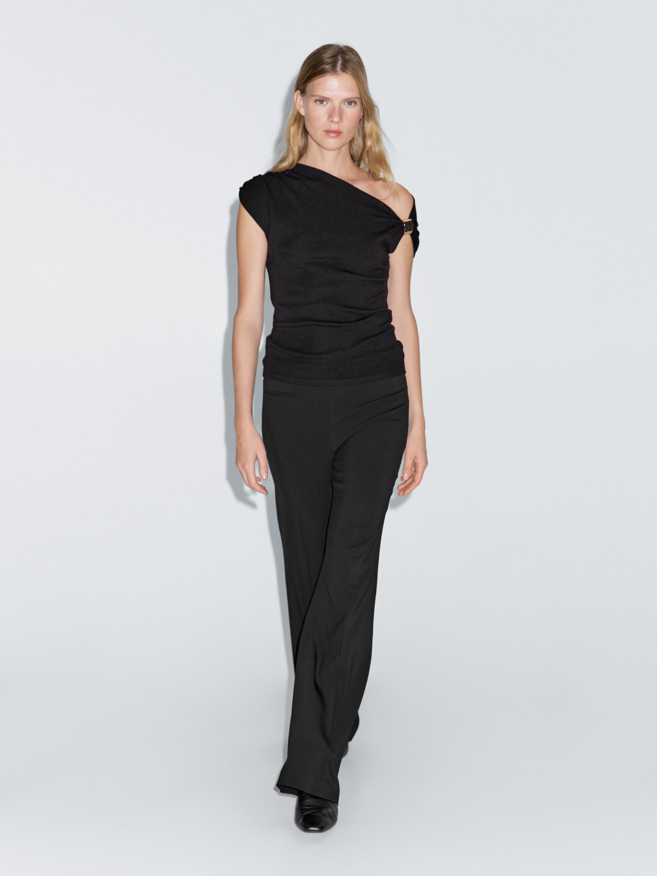 Sleeveless draped top with shoulder appliqué