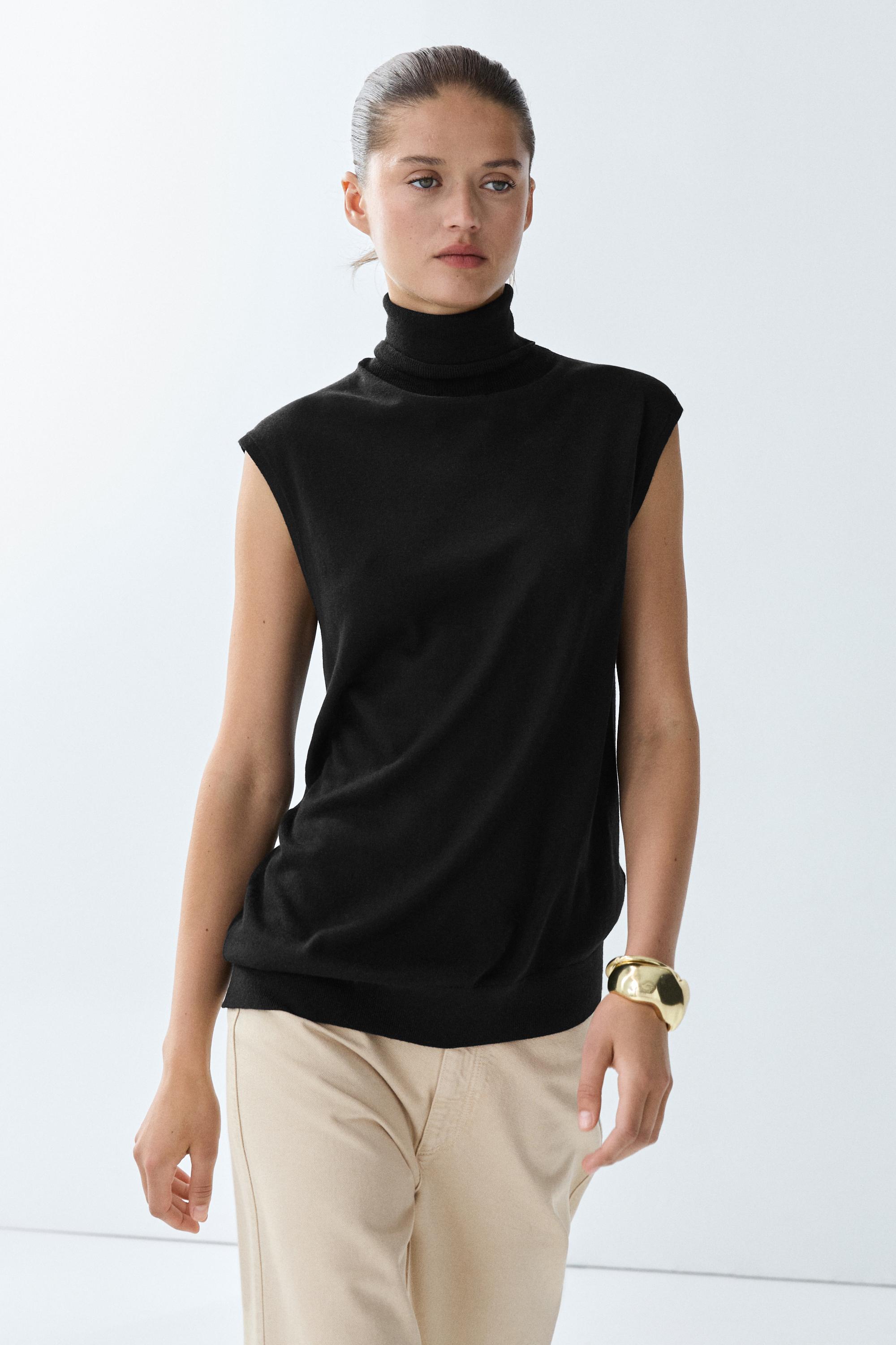 Asymmetric hem turtleneck top — BLACK