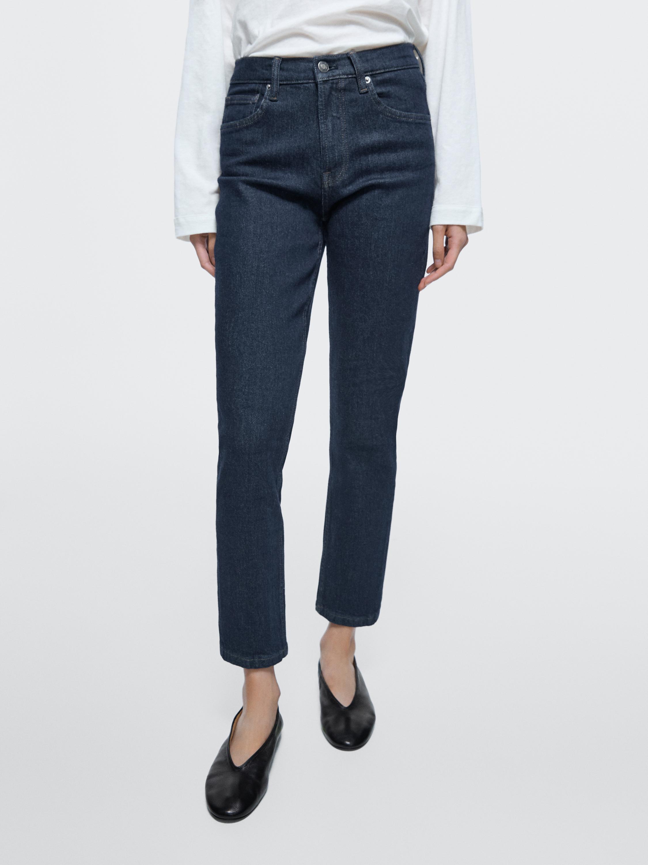Dark blue slim fit cropped mid-rise jeans set with visible front and back pockets.