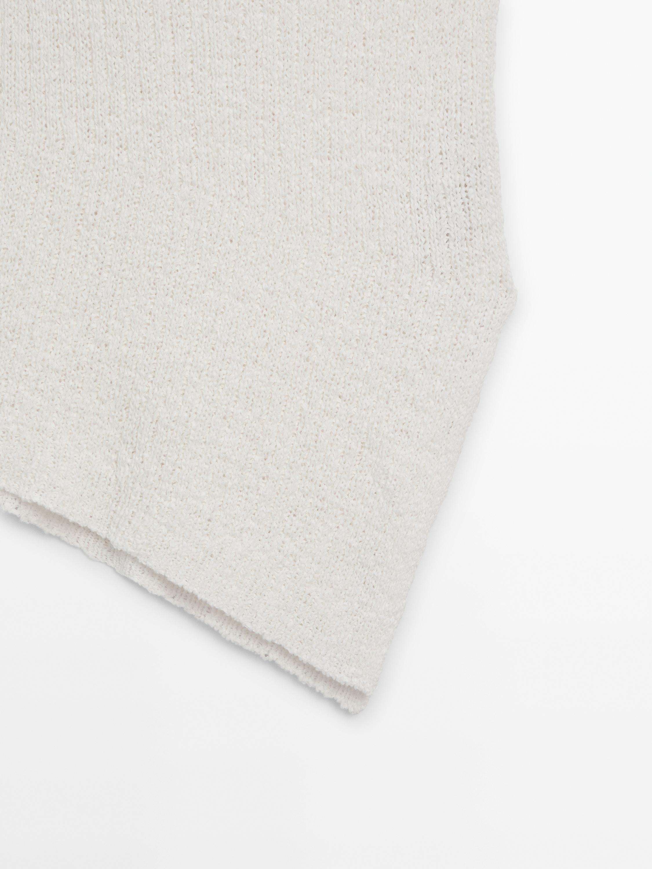 Knit top with asymmetric hem