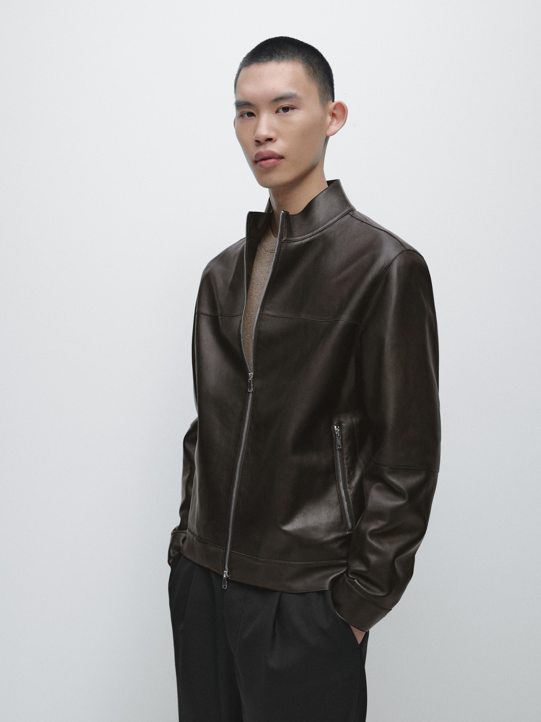 Brown bomber jacket set with a front zipper and side pockets, over dark pants.