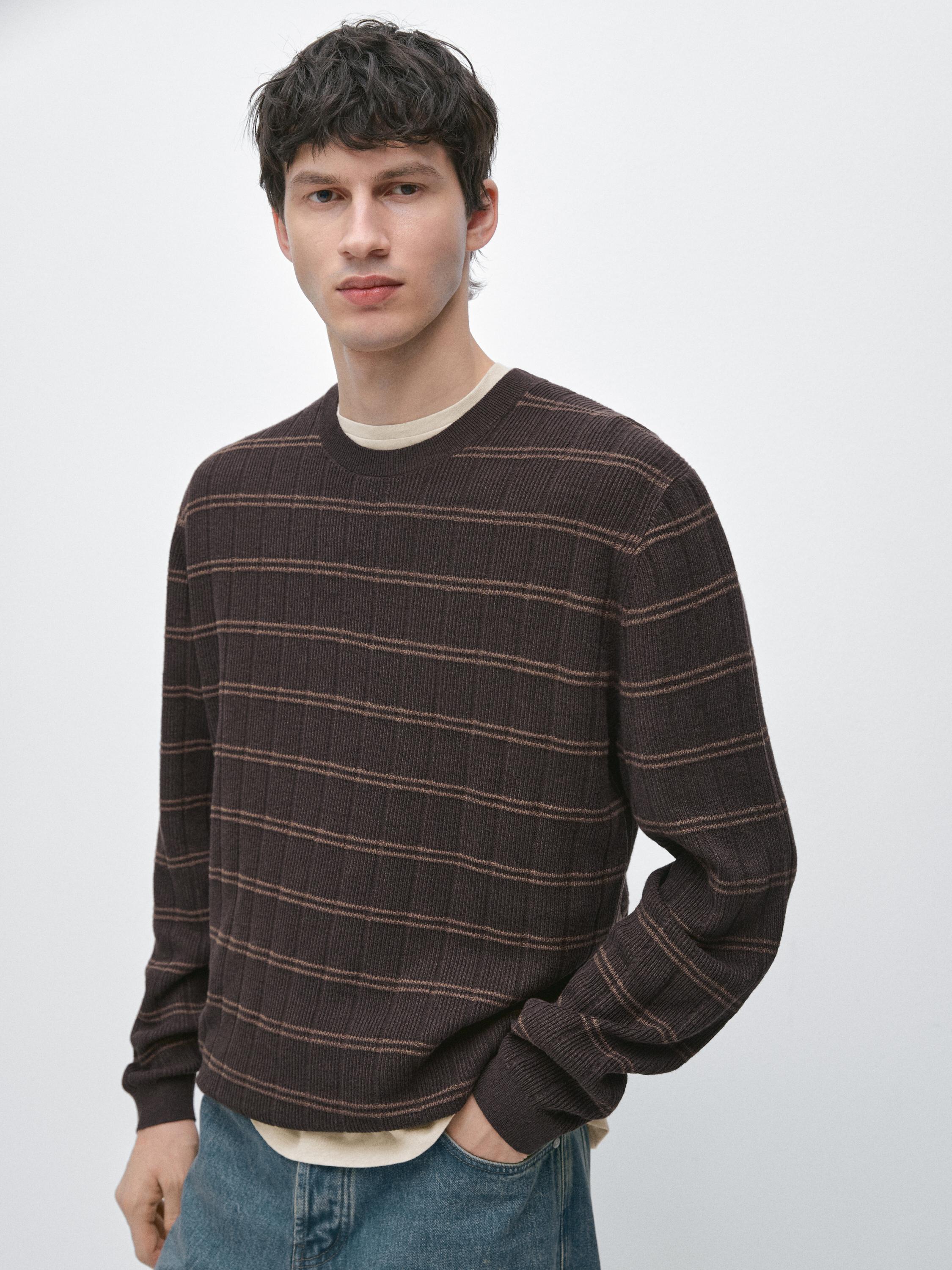 Medium shot of a brown striped jersey with a round neck and long sleeves.
