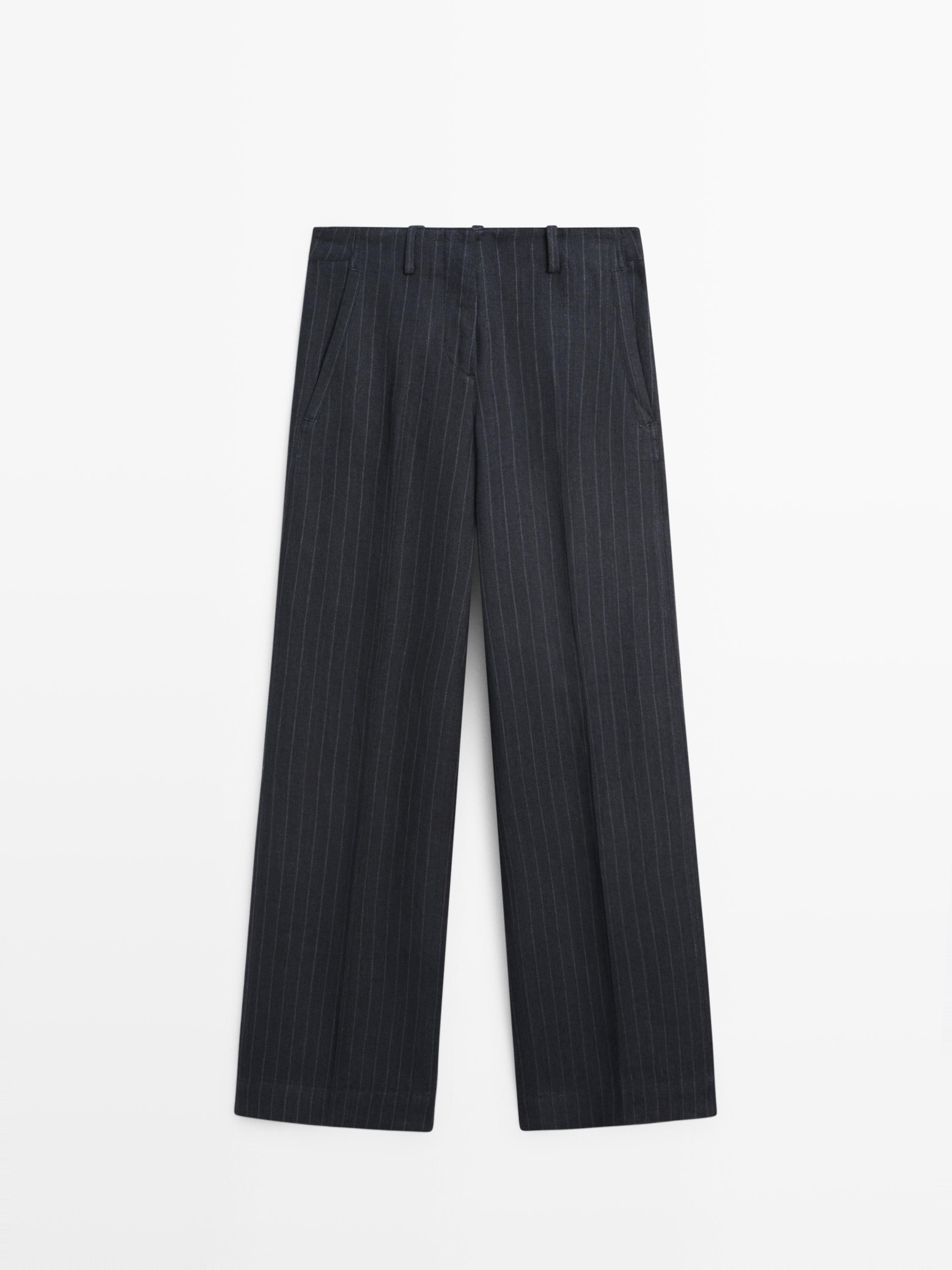 Front view of dark blue wide-leg pants with pinstripes and side pockets.