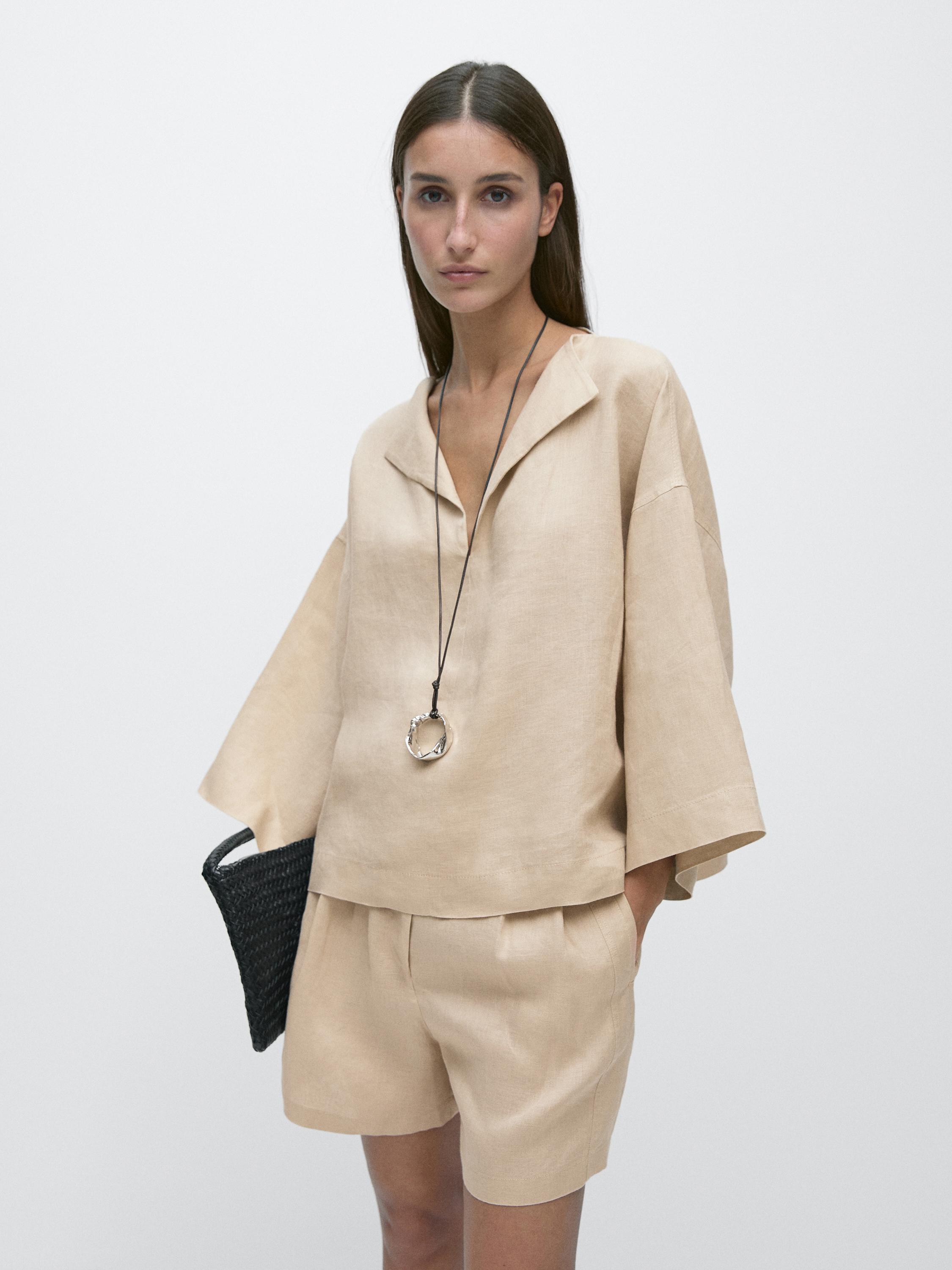 Flowy sand-colored blouse set with an open collar and wide sleeves, paired with matching shorts.