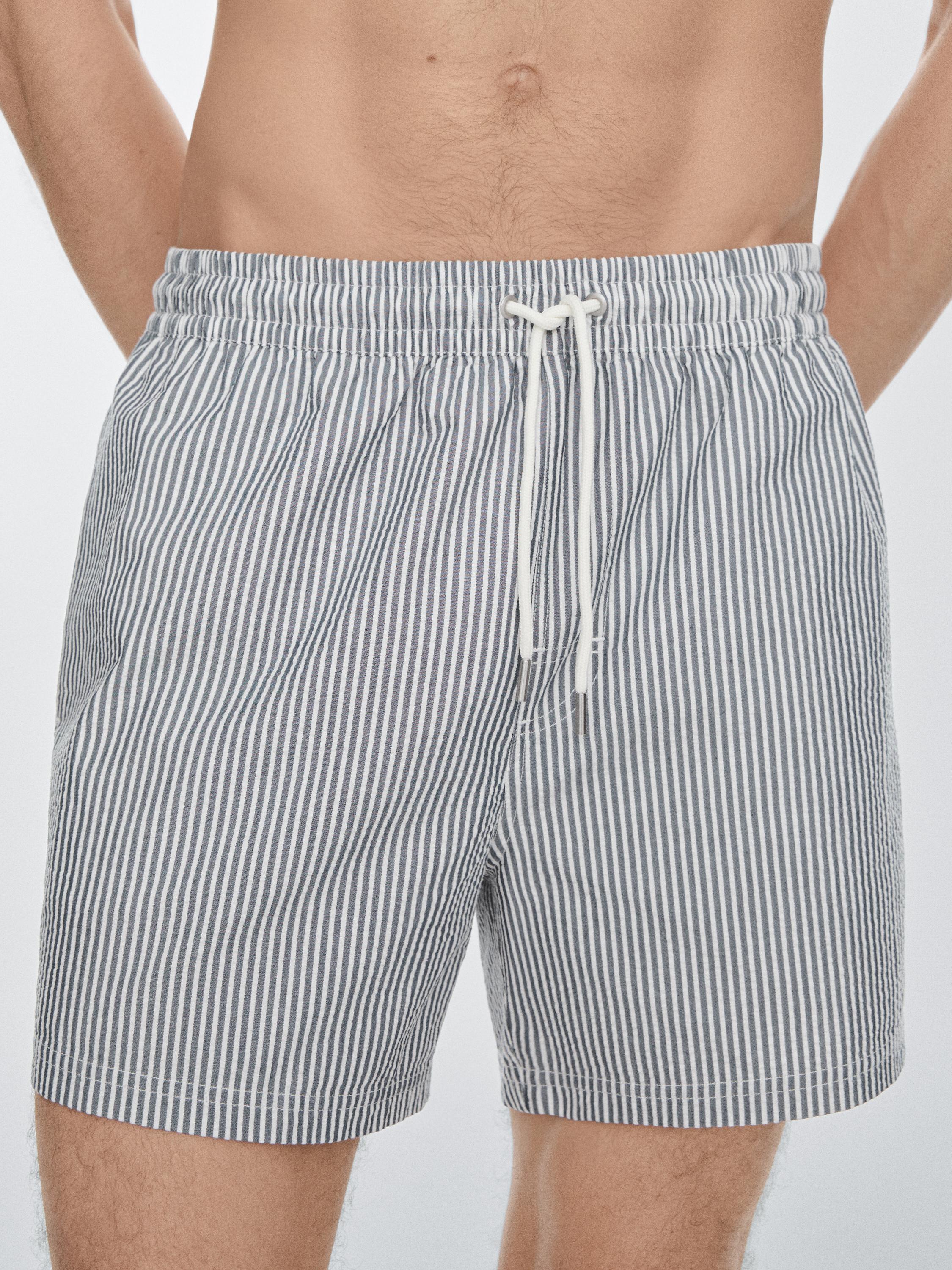 Swimming trunks with striped details