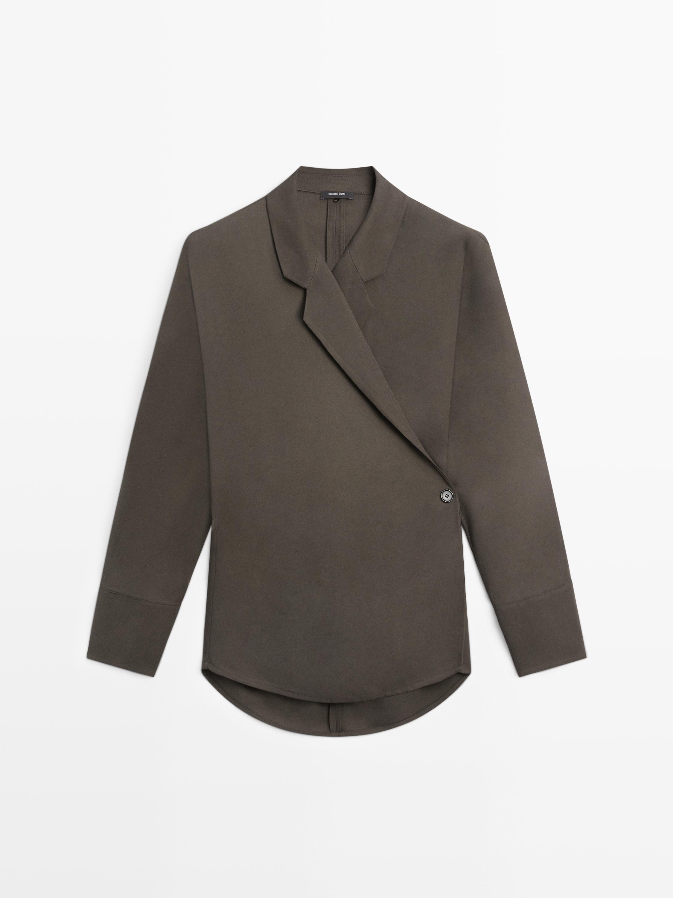Front view of a grayish-green blazer with an asymmetrical closure and a side button.