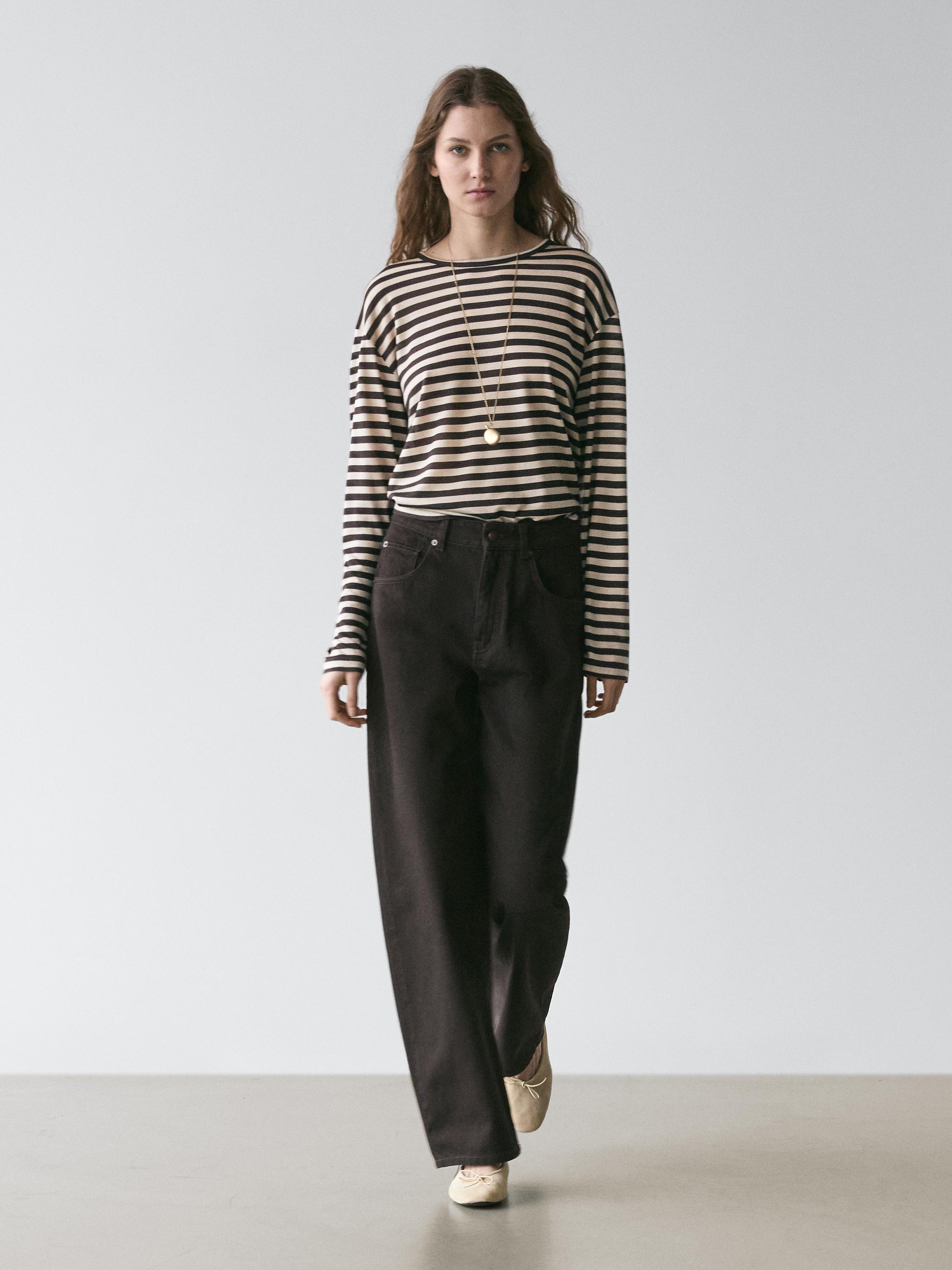 Brown striped long-sleeve T-shirt and black wide-leg pants with side pockets set.