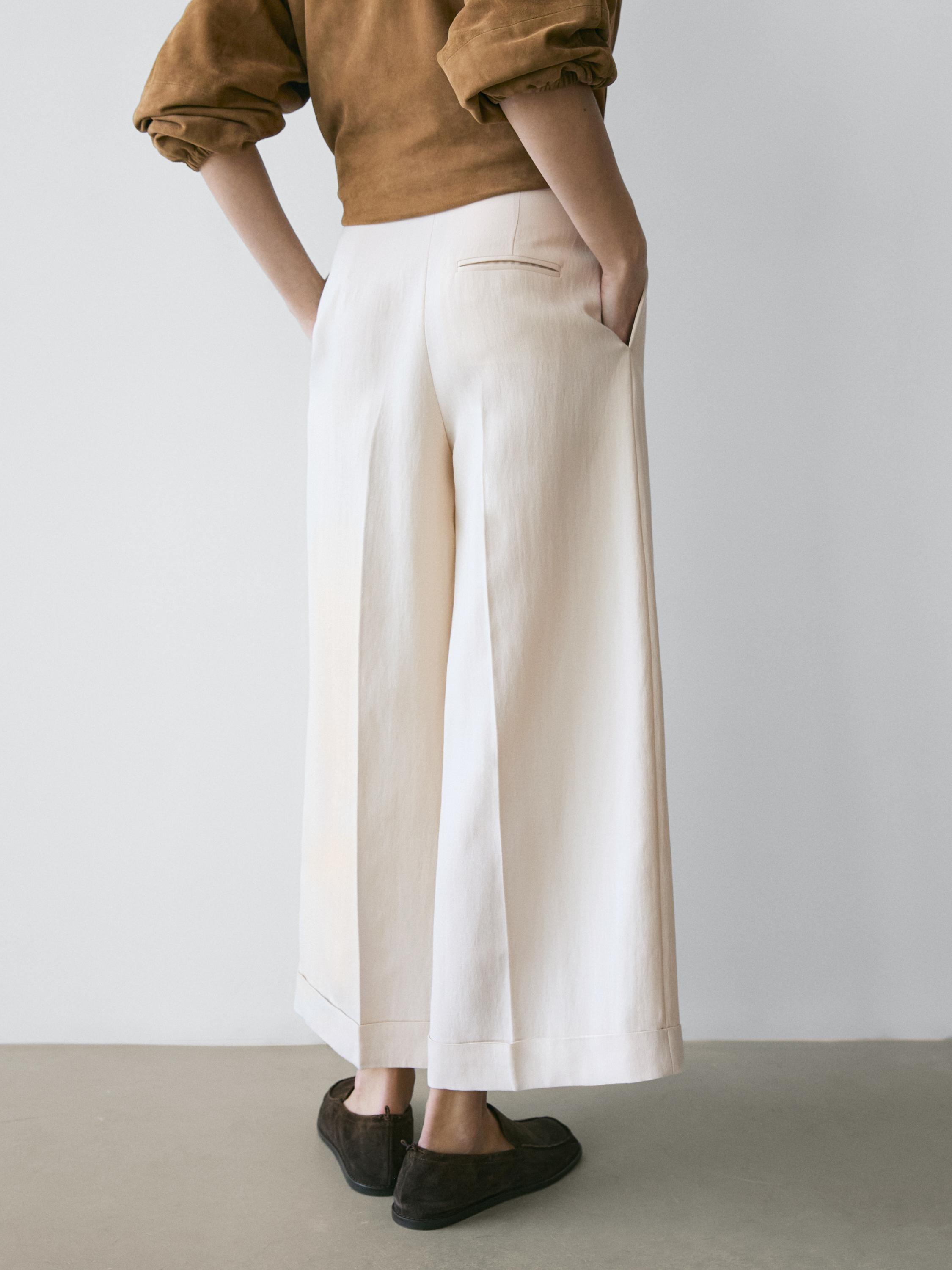 Flowing trousers with turn-up hems — CREAM