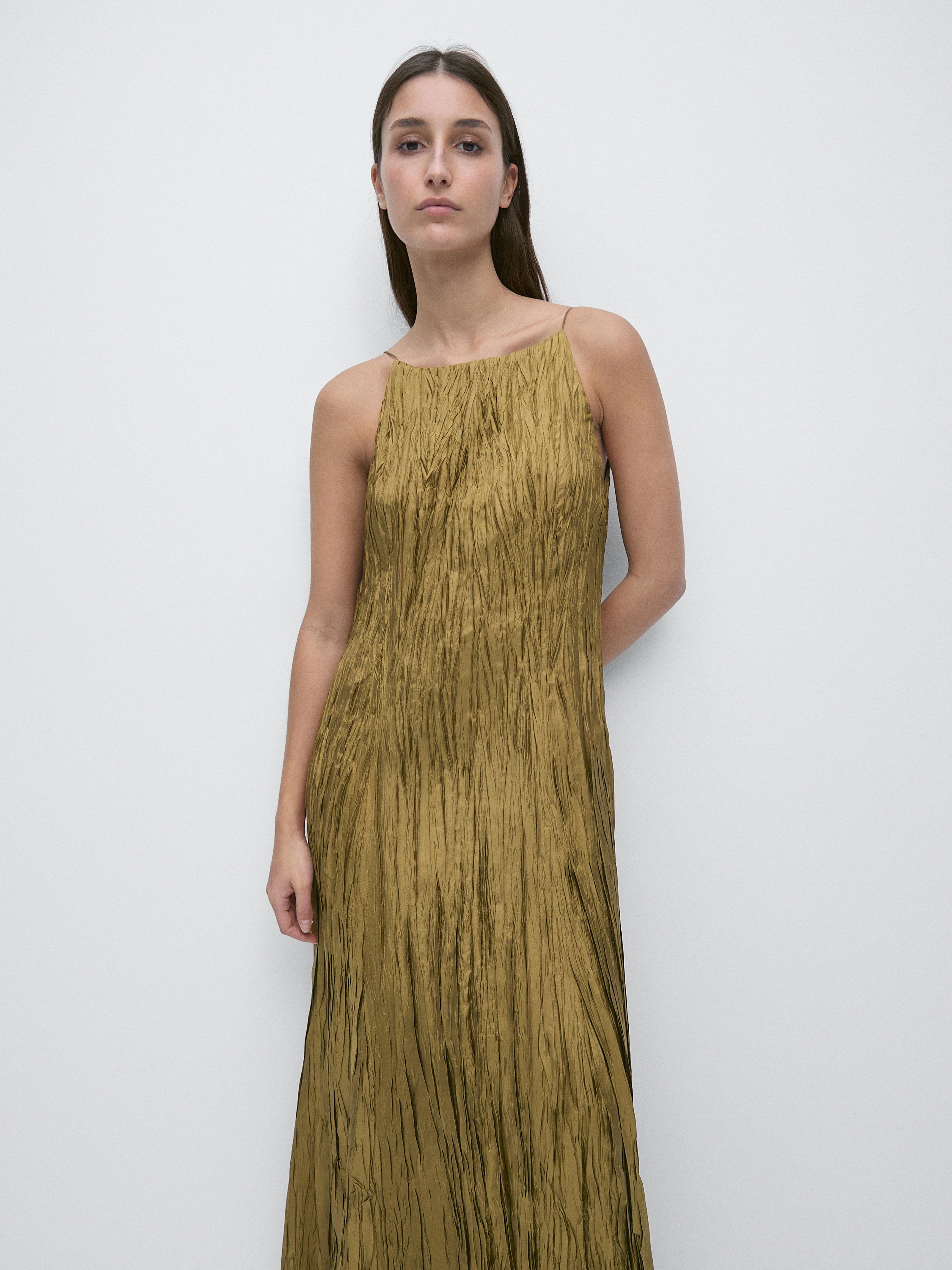 Flowy green long dress set with a halter neck and crinkled texture.
