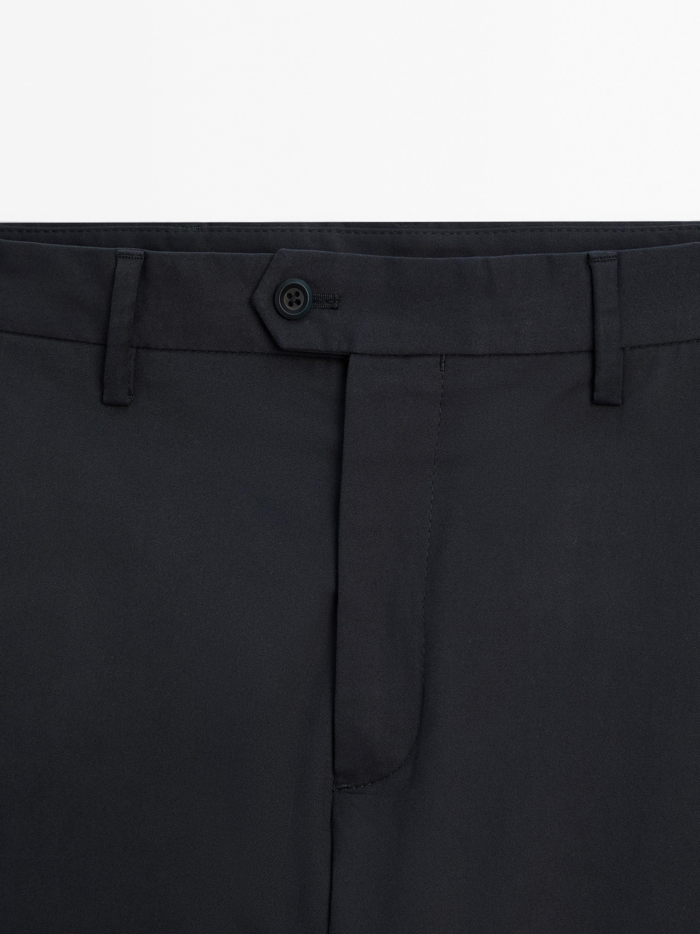 Tapered fit trousers with buckle detail