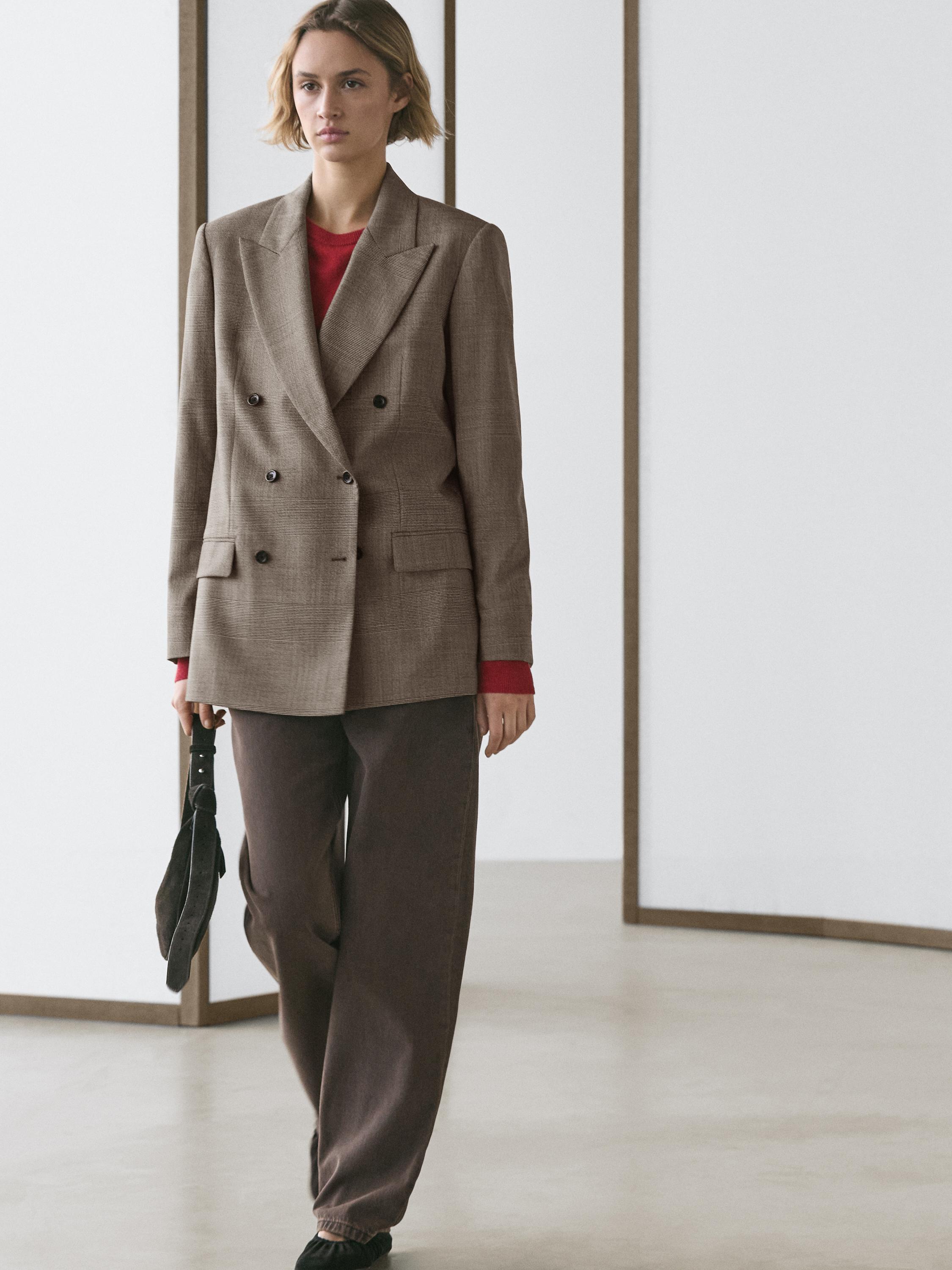 Double-breasted beige blazer set with front pockets and loose brown pants. Red t-shirt visible underneath.