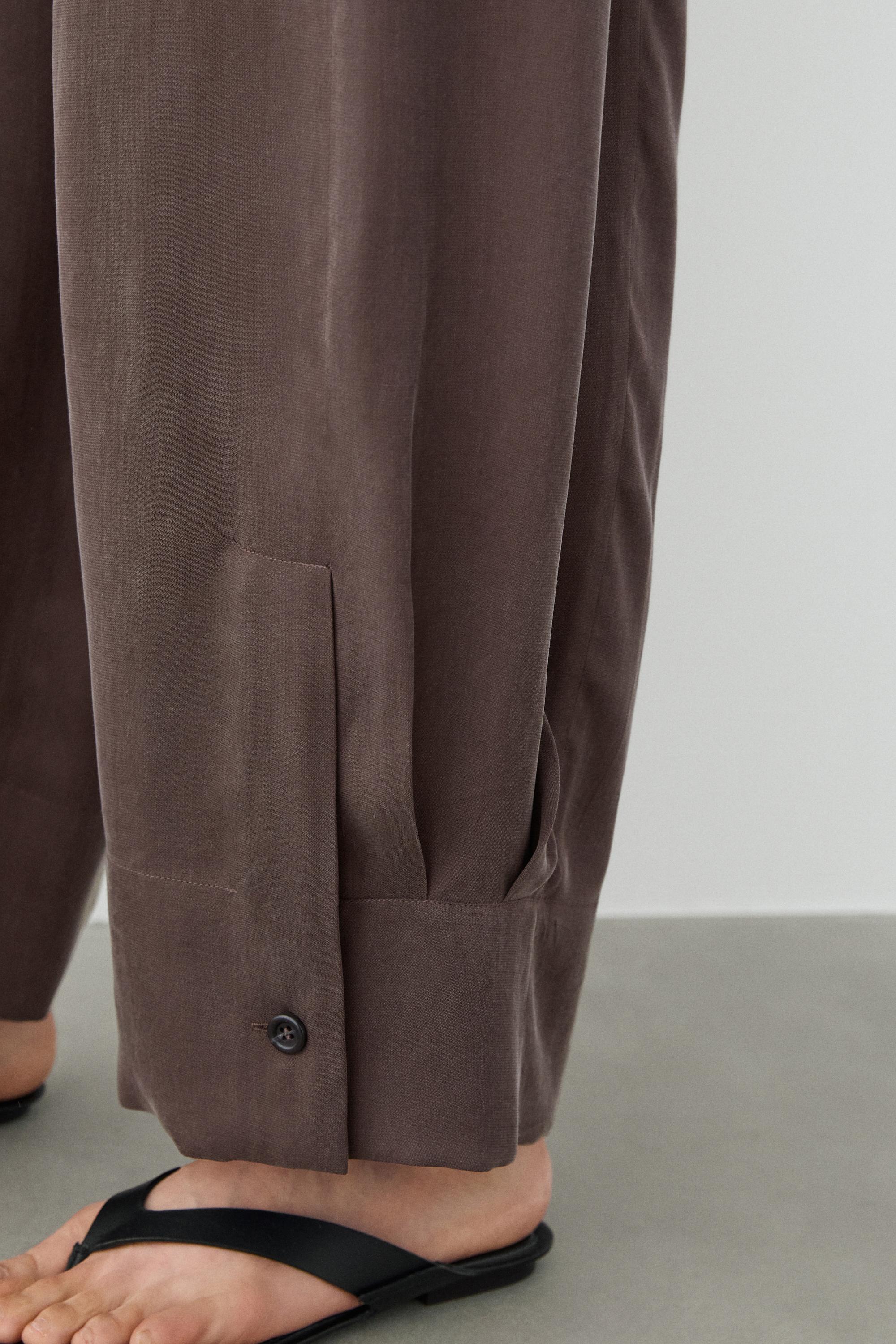 Total look flowing trousers with buttoned hems — PLUM