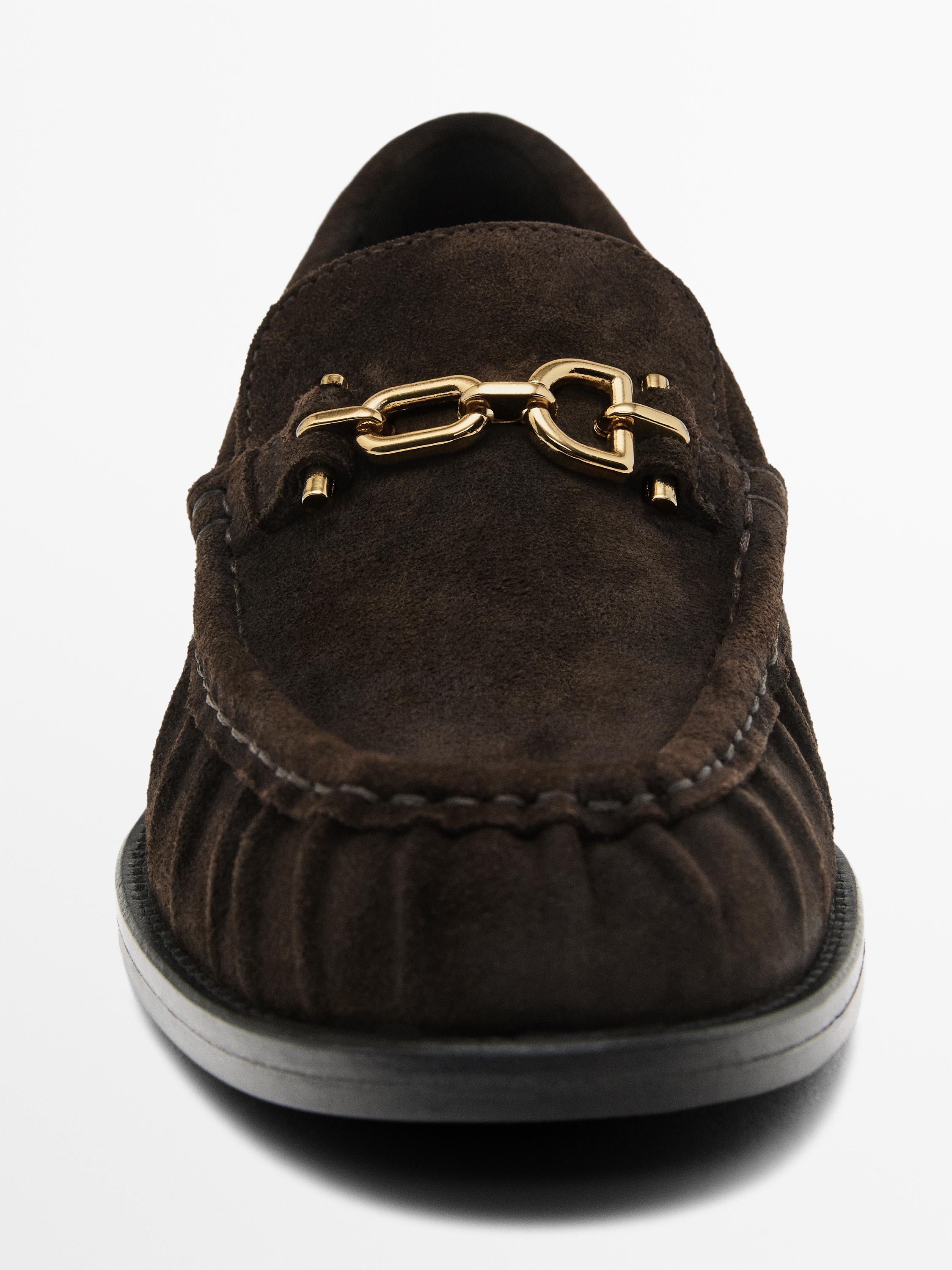 Split suede loafers with metal appliqué