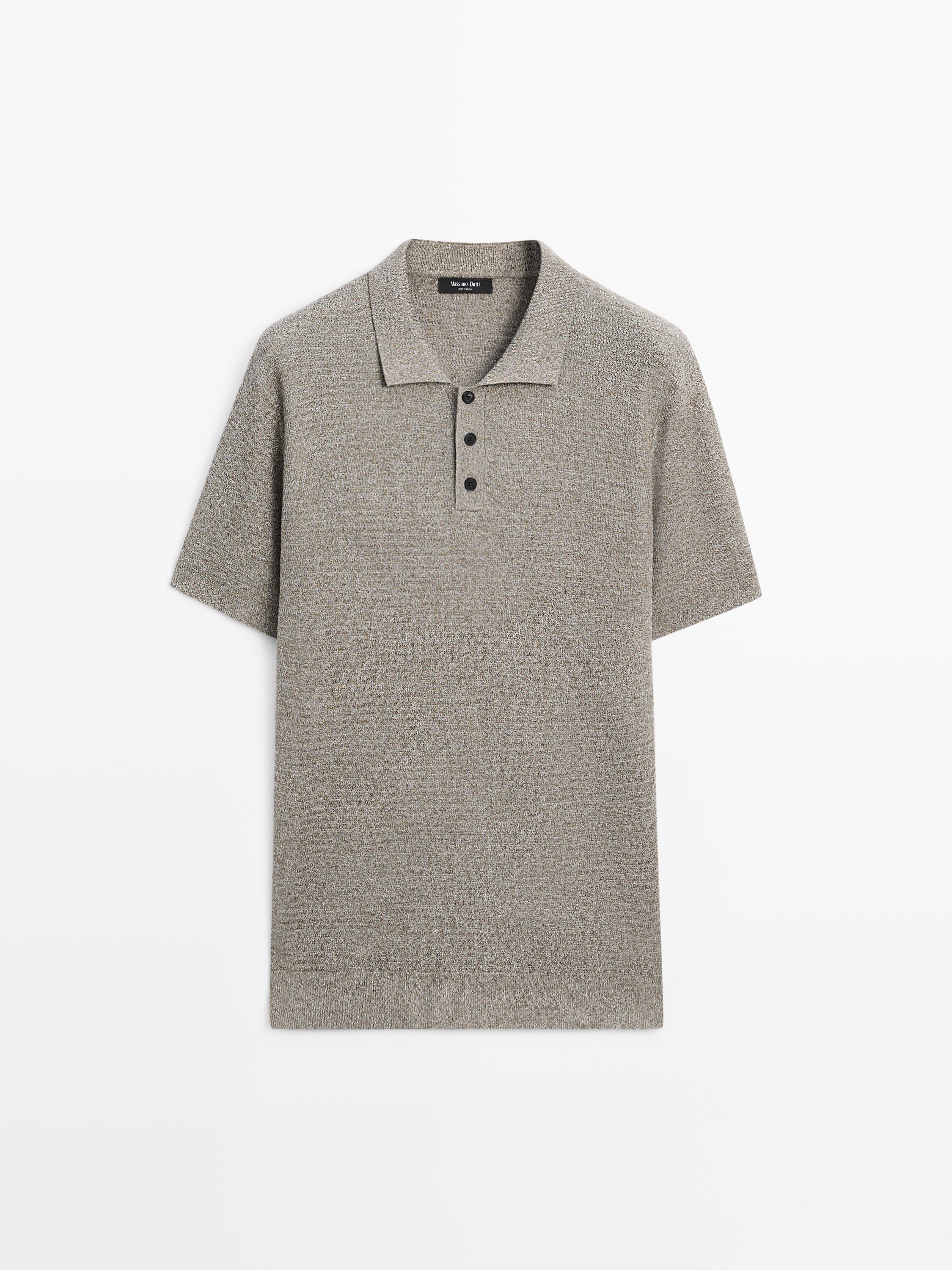 Front view of a light khaki knit polo shirt, short sleeves, classic collar with three dark buttons.