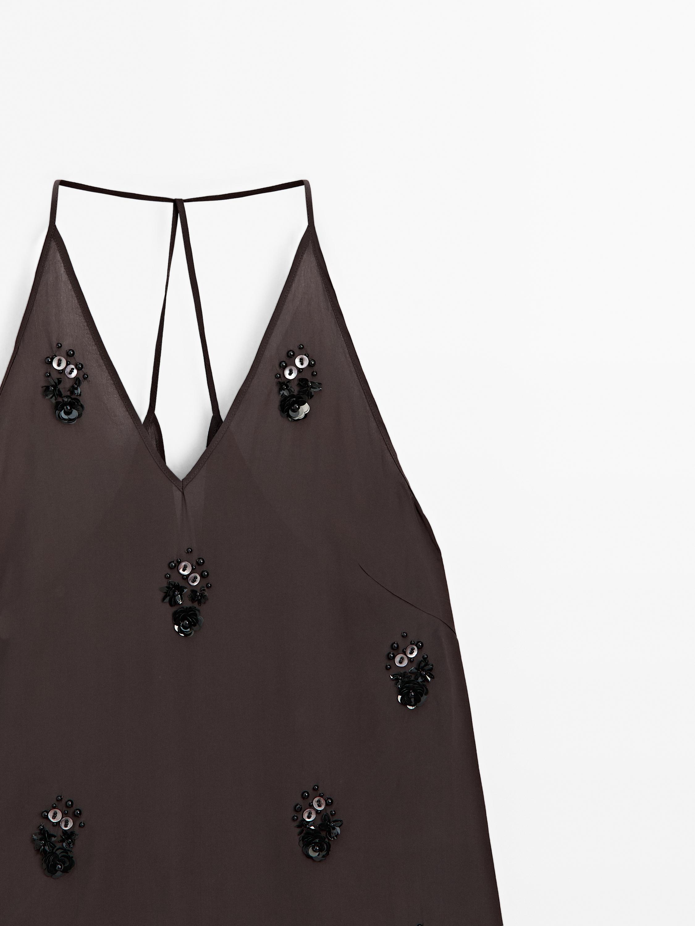 Flowing top with floral appliqués
