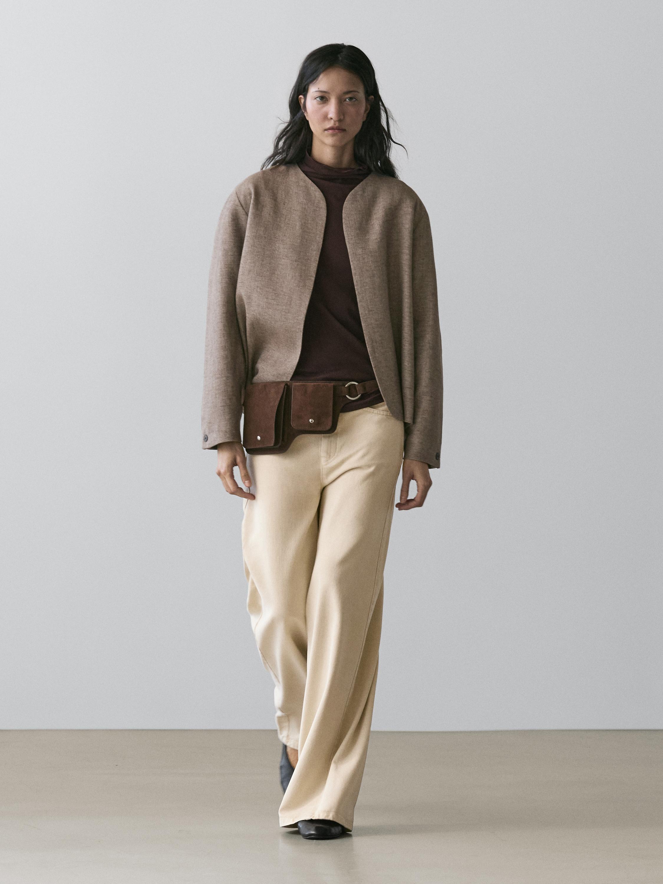 Taupe blazer set, dark brown sweater, wide beige pants, and brown fanny pack.