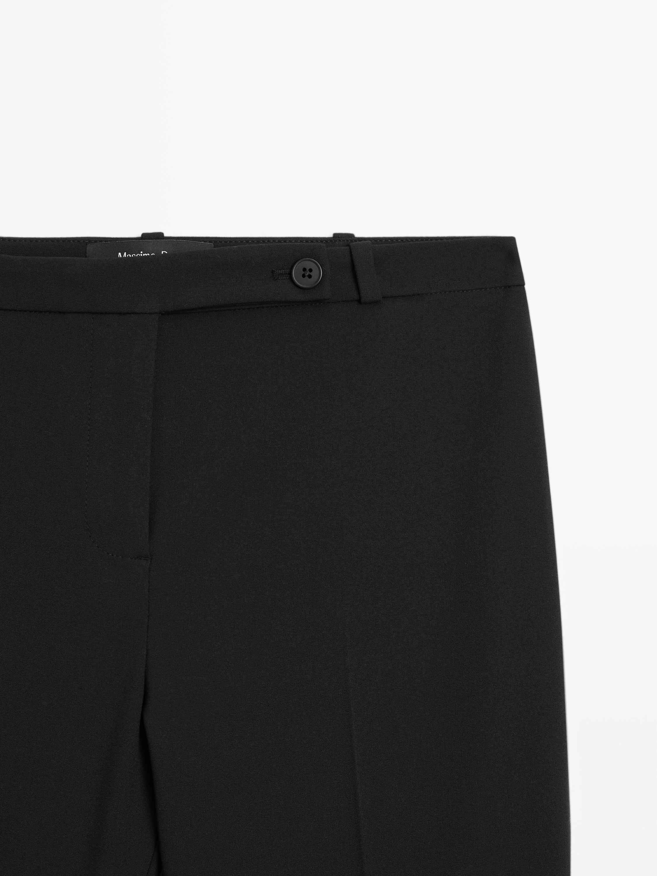 Pantaloni con pince e dettagli elasticizzati sull'orlo