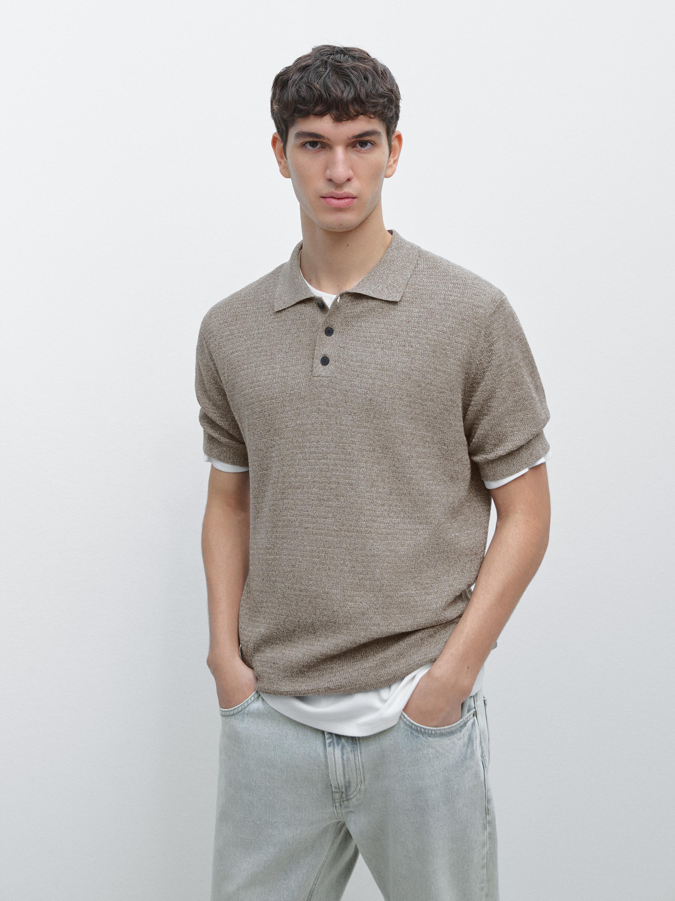 Light khaki knit polo set with short sleeves and front buttons, paired with light jeans.