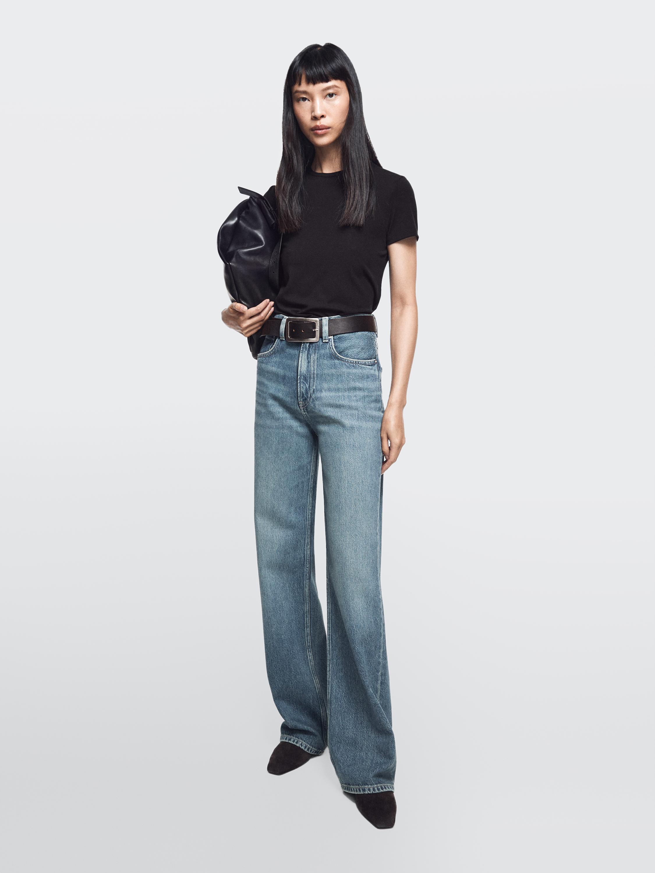 Medium blue wide-leg high-waisted jeans set with a black t-shirt. Jeans with front and back pockets.