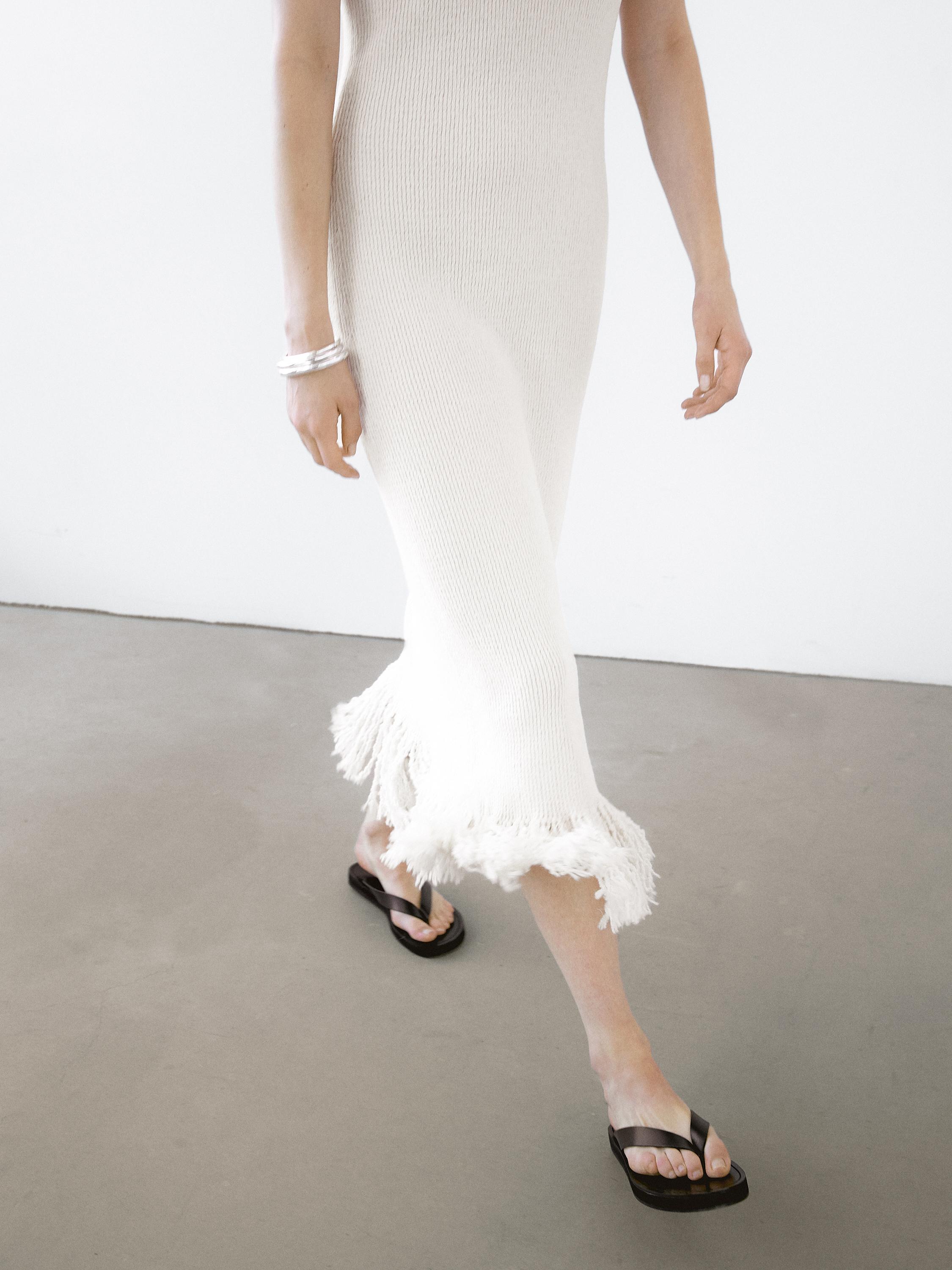 Knit dress with fringed hem