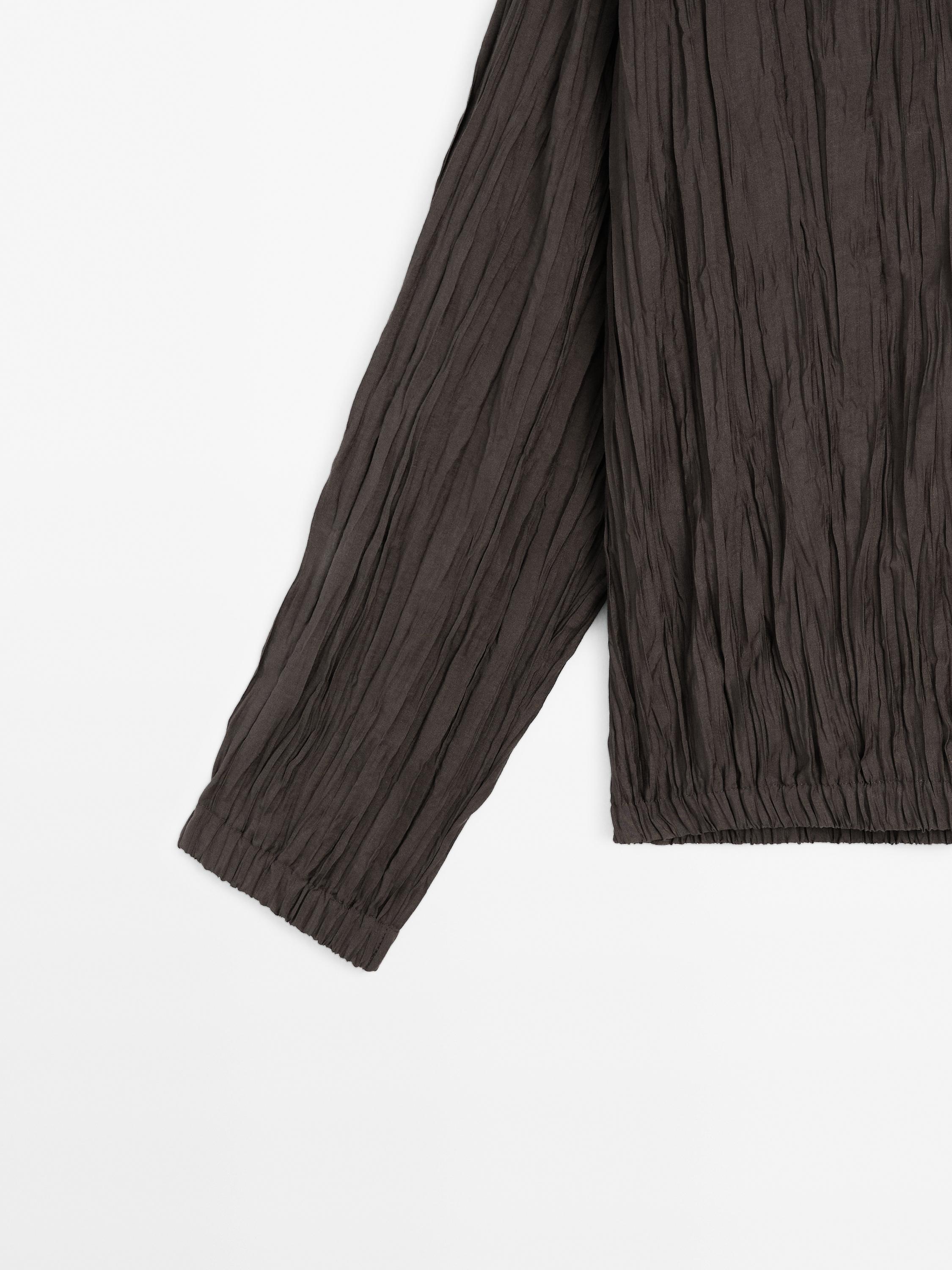 Flowing pleated bomber-style shirt