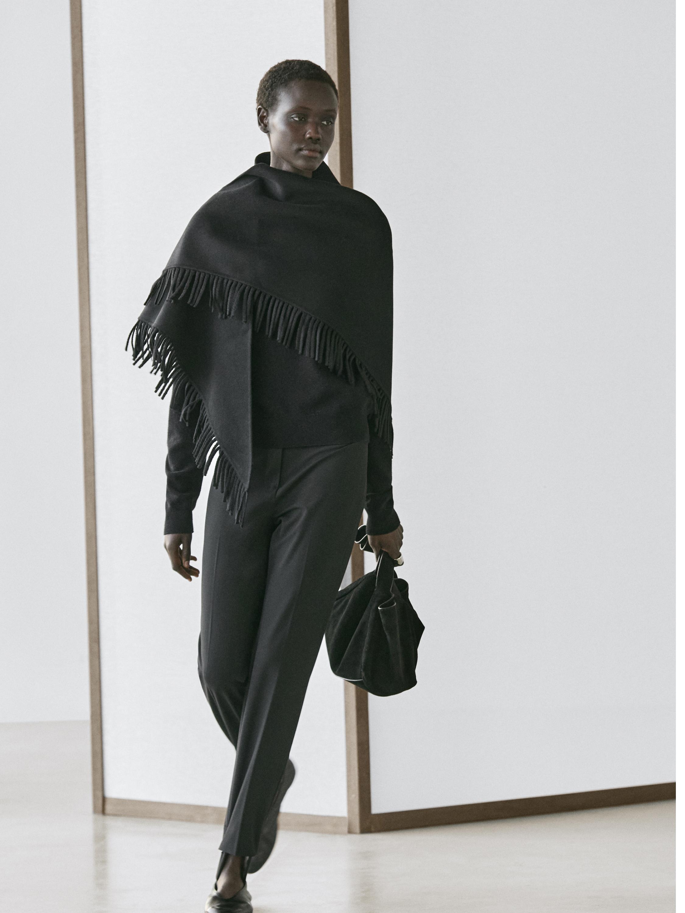 Black pants set with elastic cuffs and black fringed shawl.