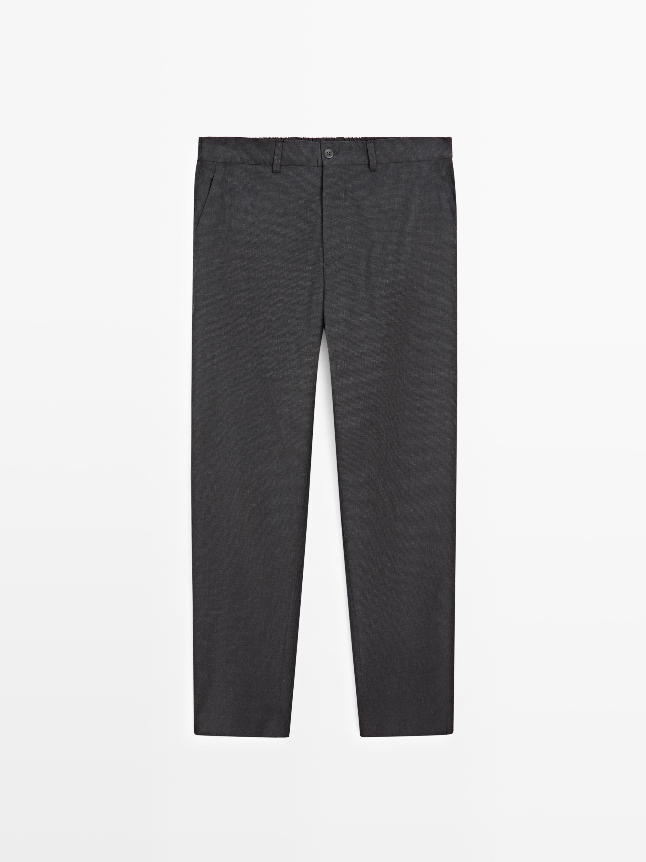 Front view of navy blue pants with side pockets and button closure.