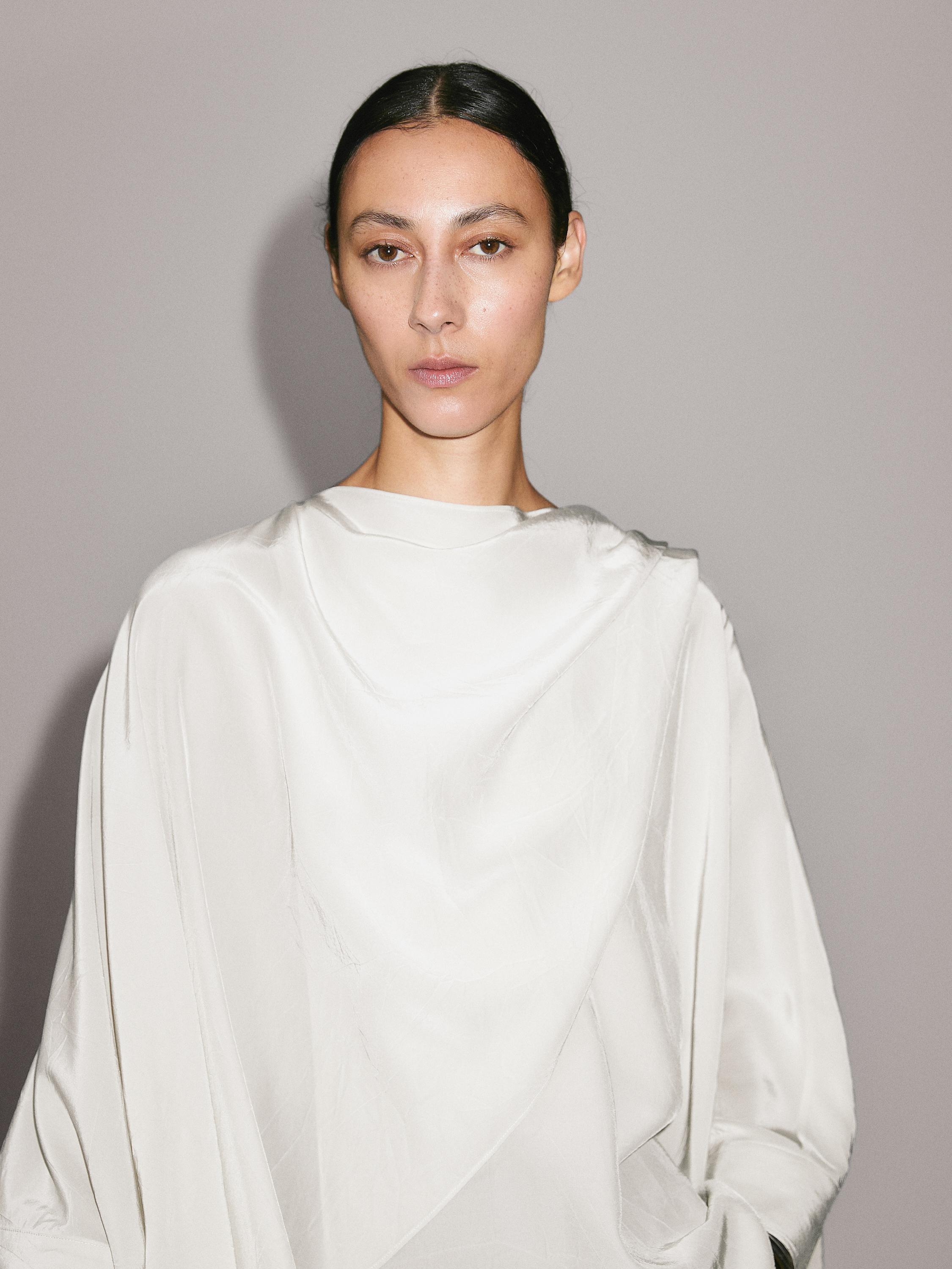 Short flowing cape with sleeve detail