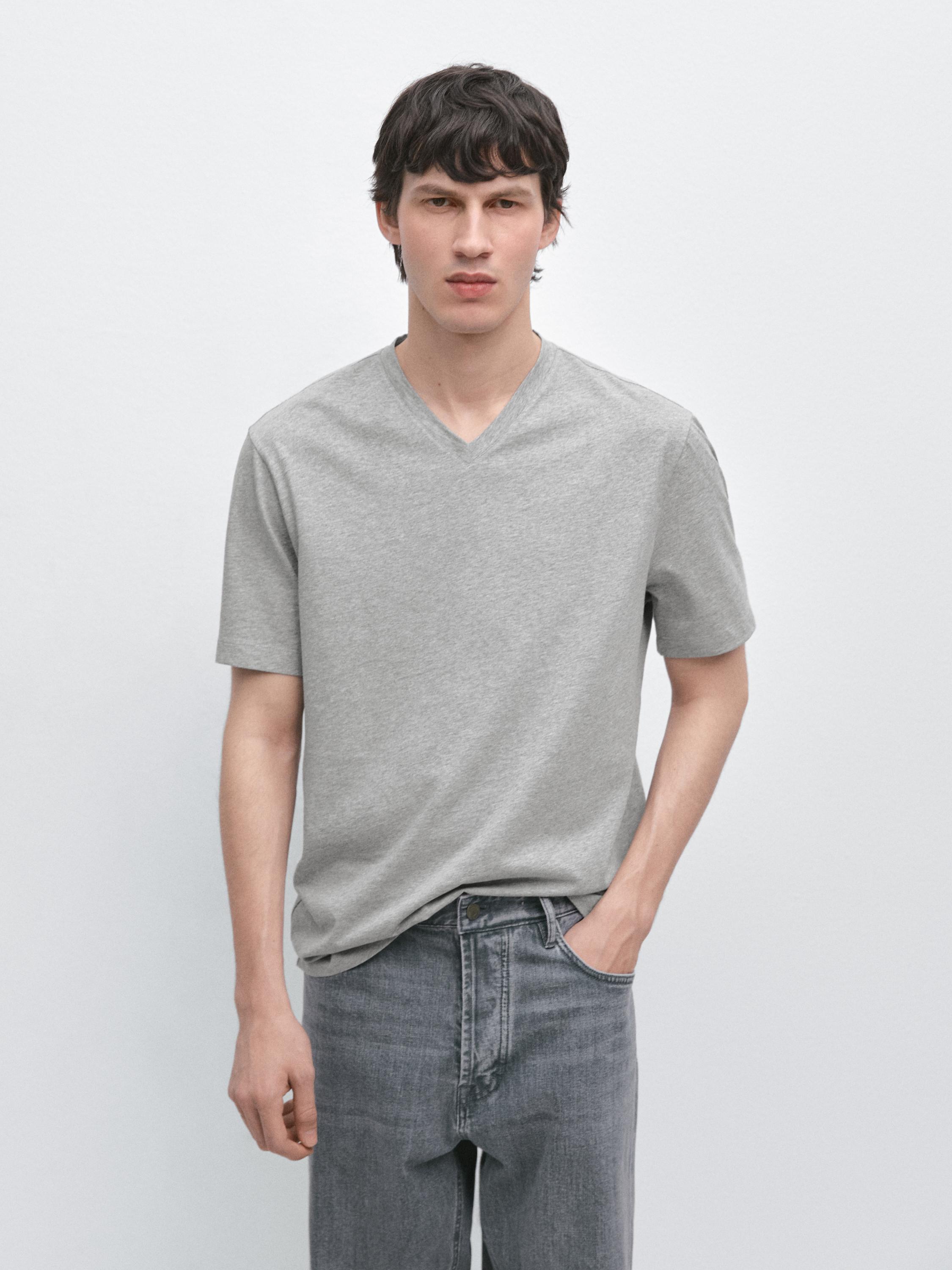 Short-sleeved, V-neck heather gray t-shirt and matching gray jeans.