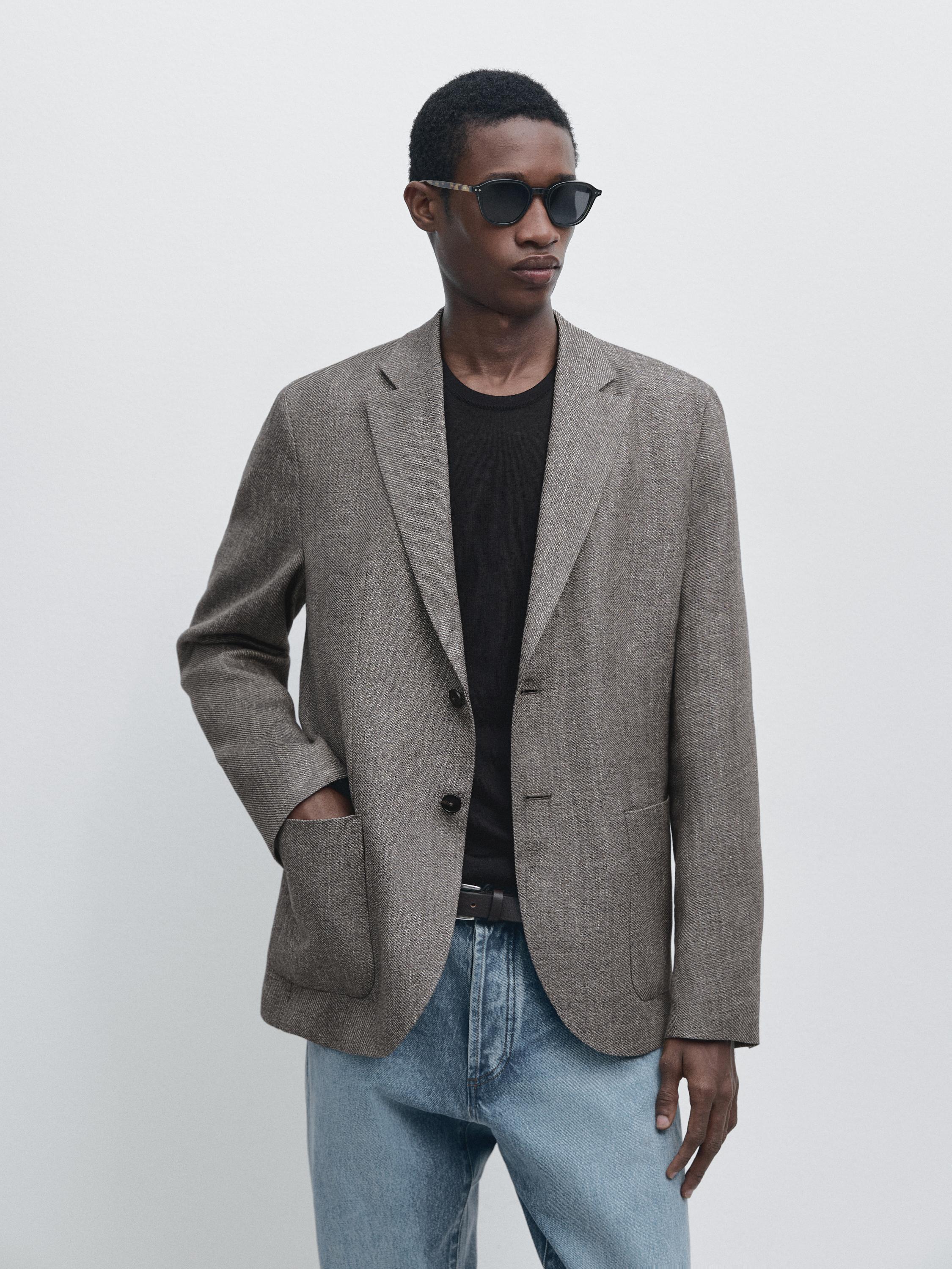 Heather gray blazer set with front pockets and a black t-shirt, paired with blue jeans.