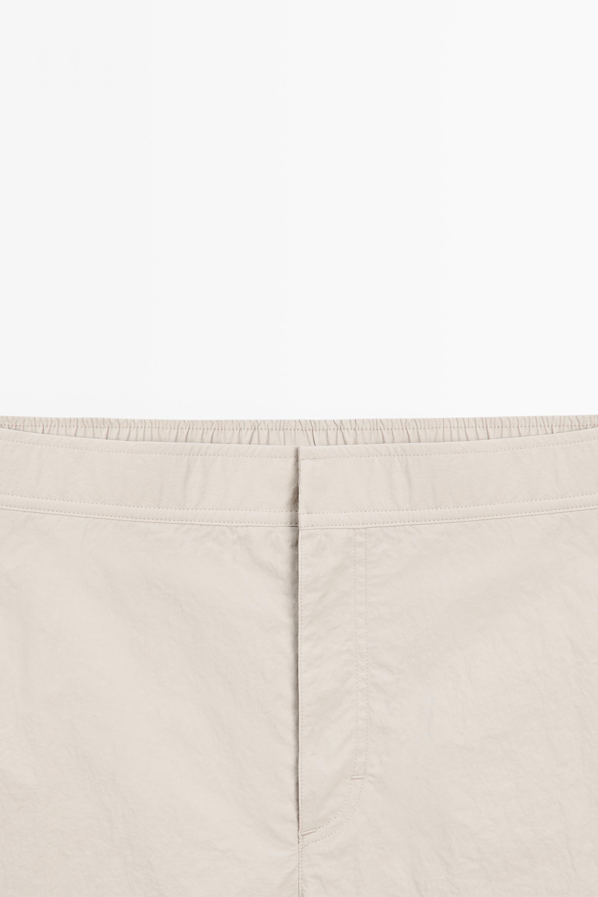 Plain swimming trunks with waist detail — SAND